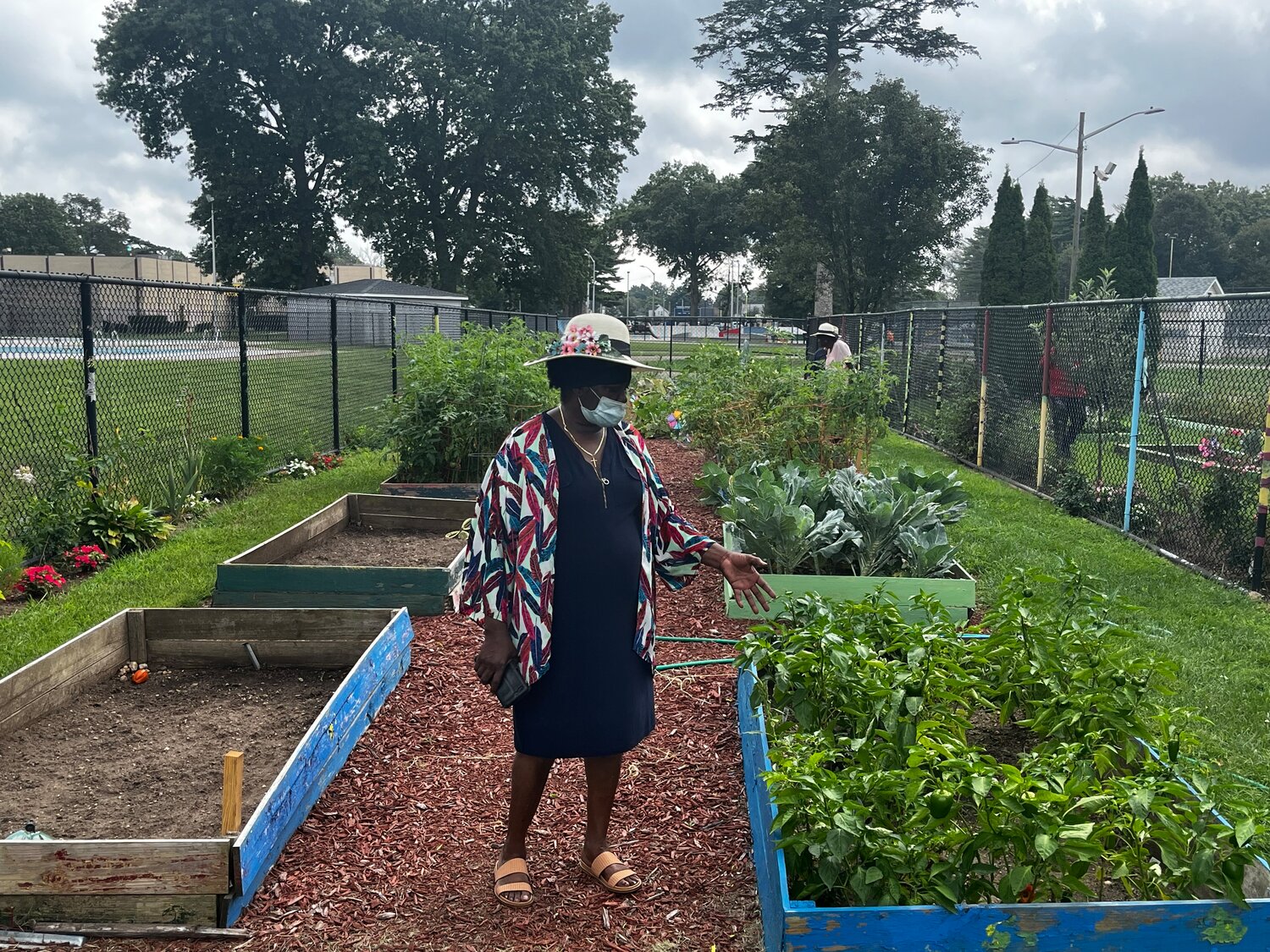 Mary Crosson, commissioner of Ligia’s Garden of Hope, in front of the community garden located at Kennedy Park in Hempstead.