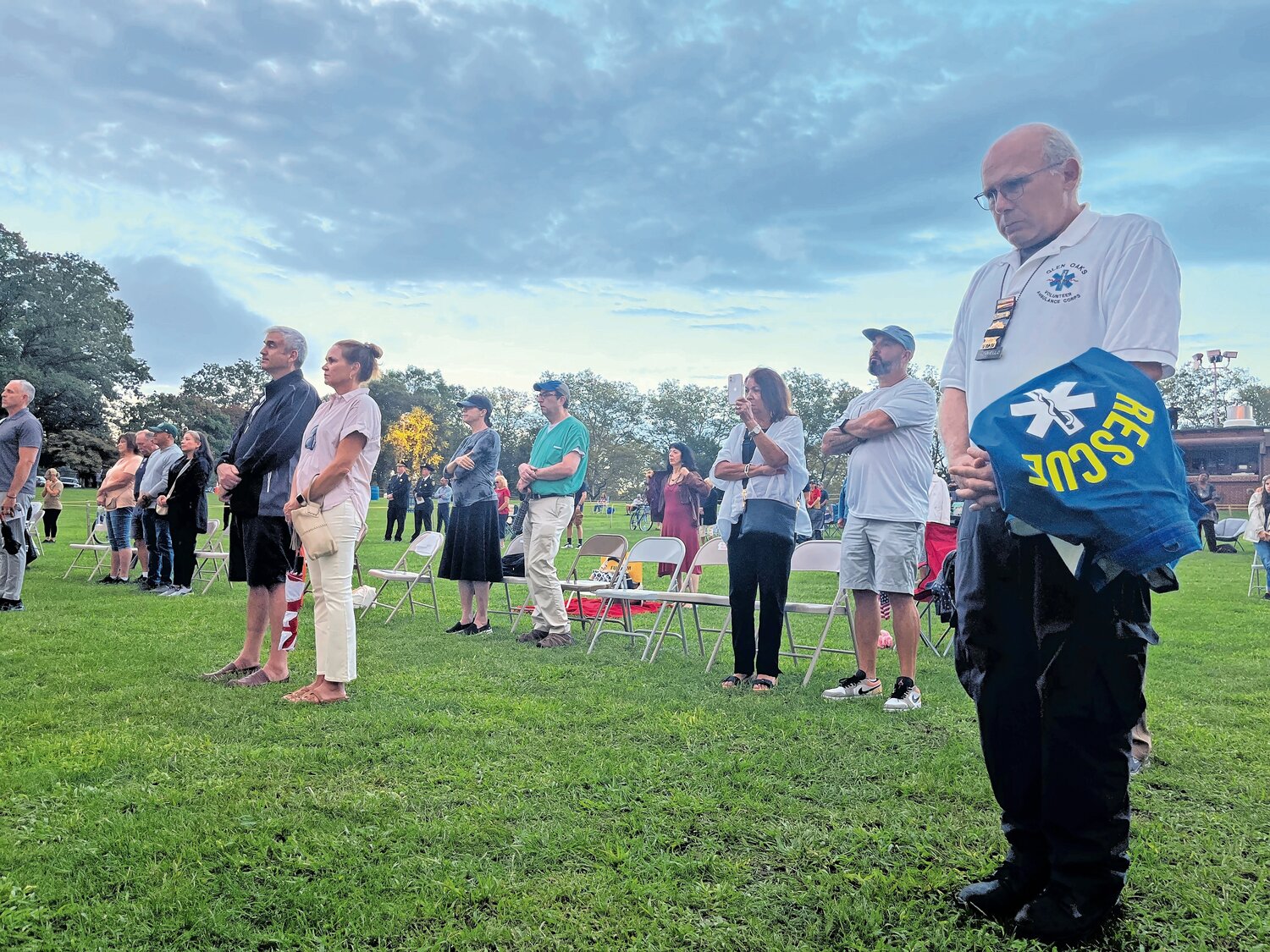 A member of the Glen Oaks Volunteer Fire Department in Floral Park stands and remembers those who were lost during the annual 9/11 Remembrance Ceremony at Eisenhower Park’s Harry Chapin Lakeside Theatre.