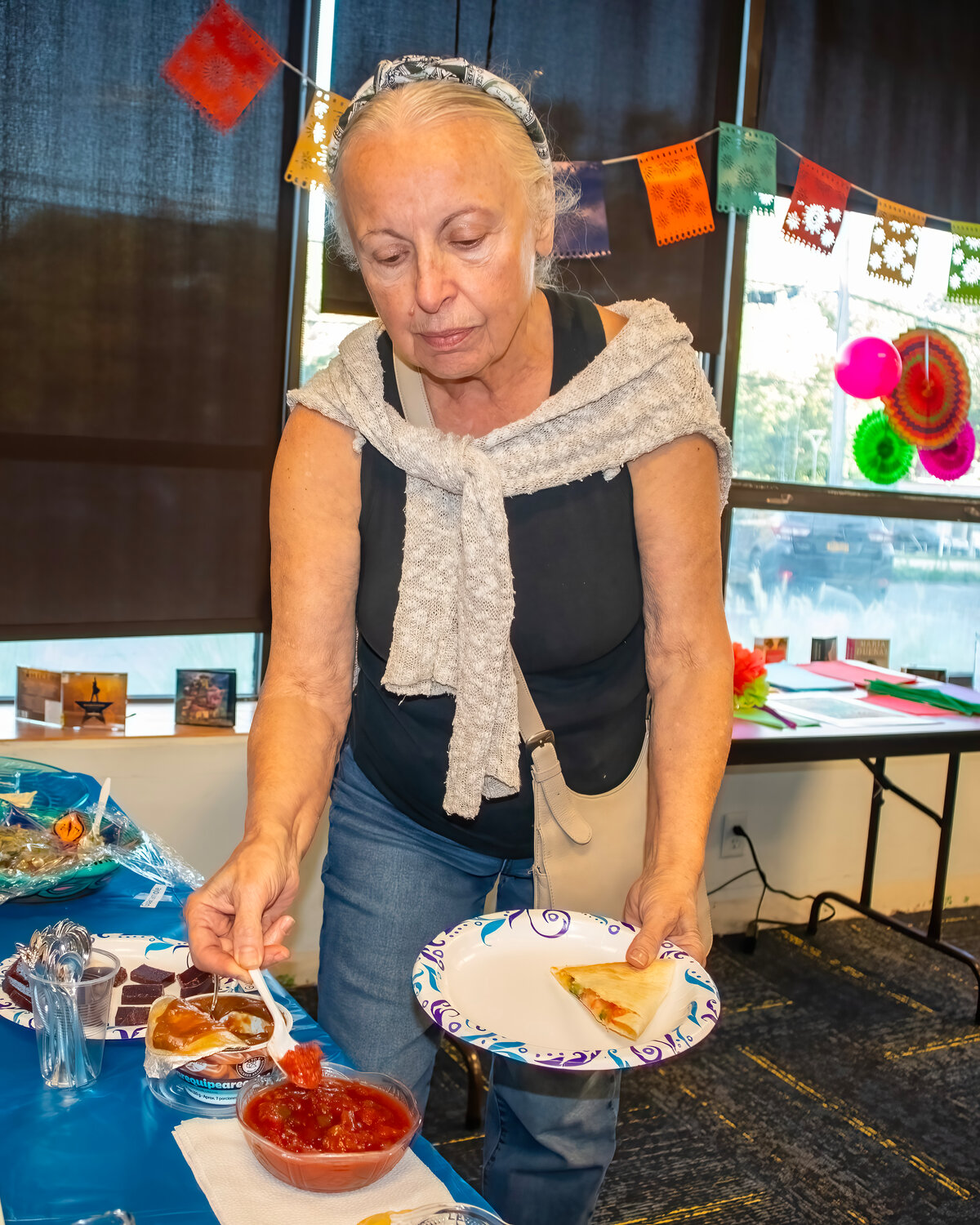 Patron Linda D’Ambrosio of Lynbrook trying some of the Hispanic Heritage food.