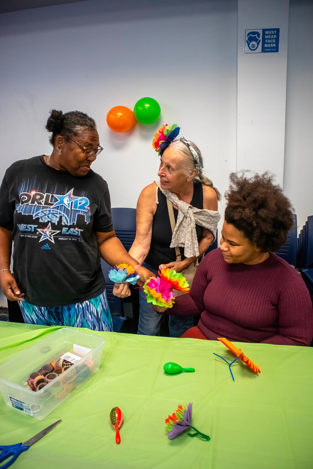Angela Hodges of Lakeview, left, with Linda D’Ambrosio of Lynbrook and Garnet Washington of Lakeview try their skills of paper flower making.