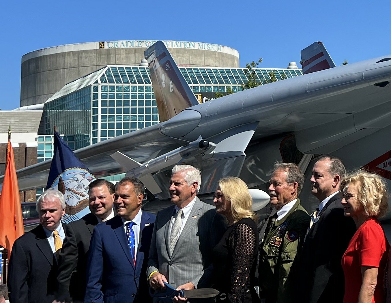 Among the officials present at the ribbon cutting were, from left, Cradle of Aviation Museum President Andy Parton, Nassau County Legislator Tom McKevitt, Town of Oyster Bay Supervisor Joseph Saladino, County Executive Bruce Blakeman, Cynthia Snodgrass, U.S. Air Force Capt. Robert “Hoot” Gibson, Vic Beck of Northrop Grumman, and County Comptroller Elaine Phillips.