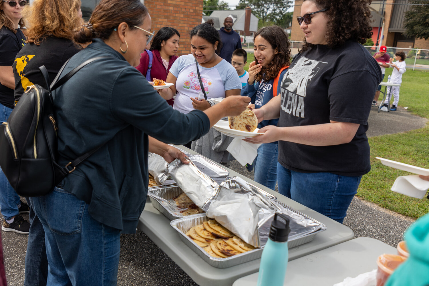 Free food being handed out to hungry parents and children, who needed energy after running around playing soccer all morning long.