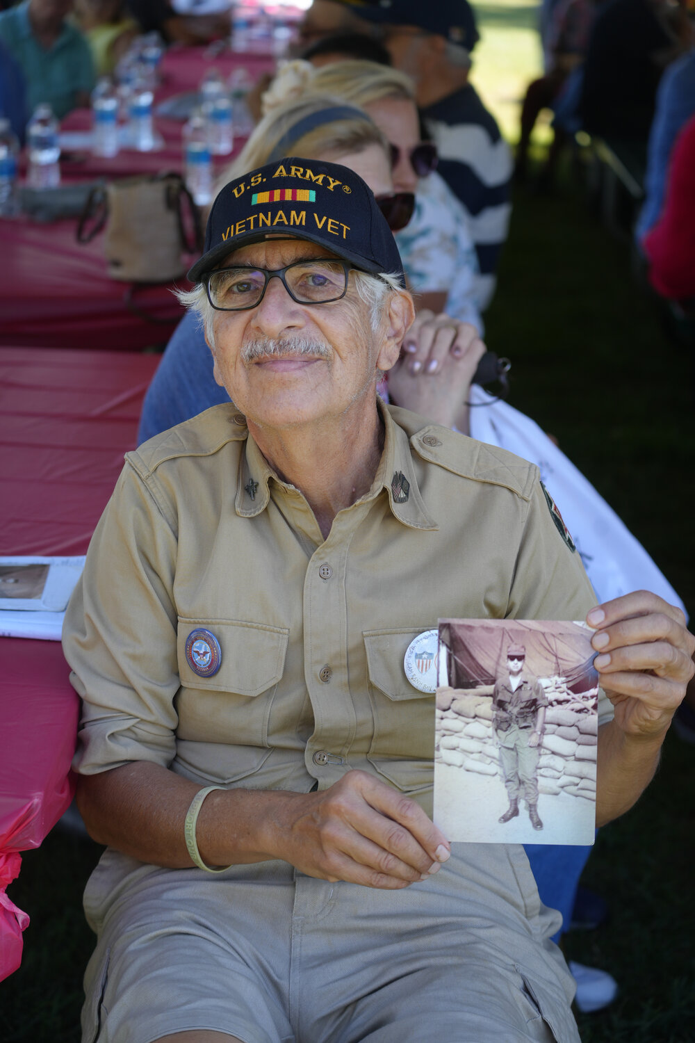 Veteran John Fackre with a photo of himself when he was deployed overseas.
