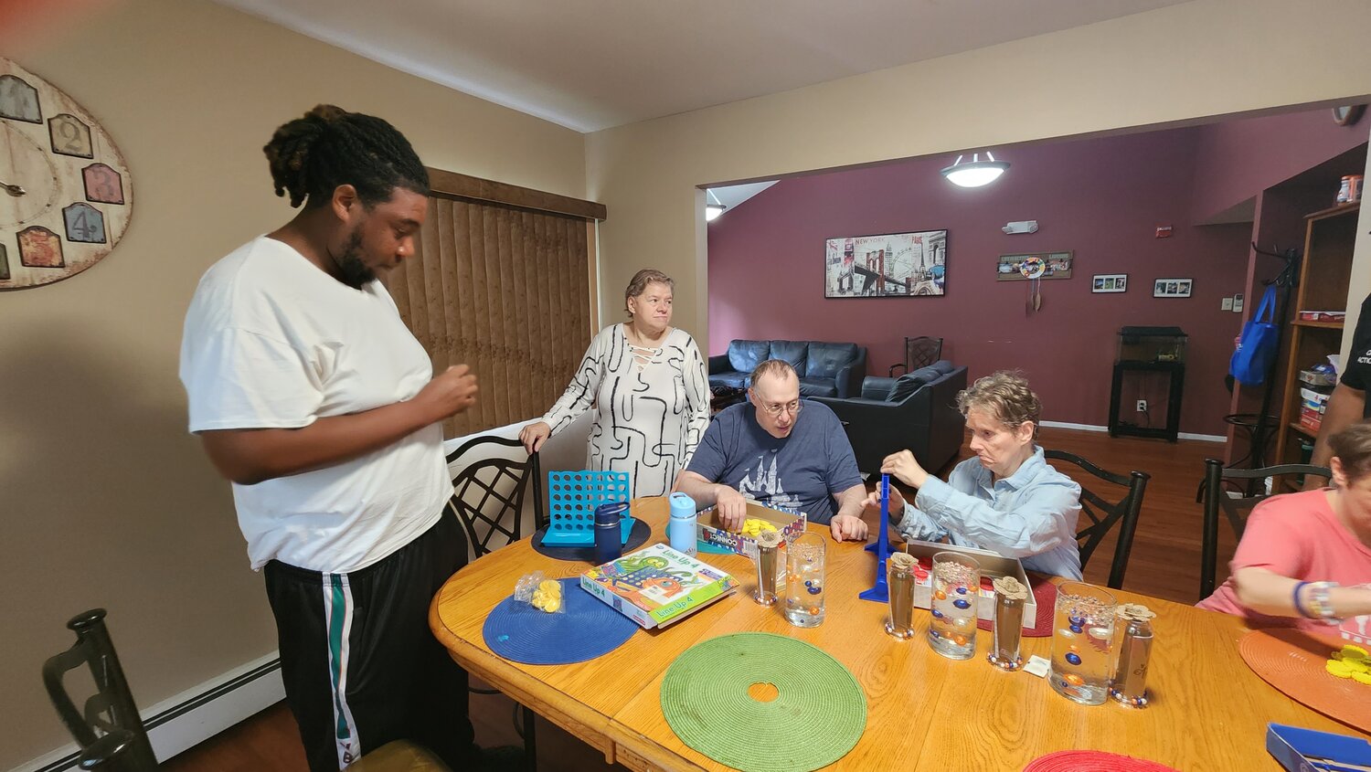 Juon Hodge plays many board games with residents Pauline Wisz, Dean Davidson and Eileen Ewald.  Quality time like this forms strong bonds that make the residence truly feel like home.