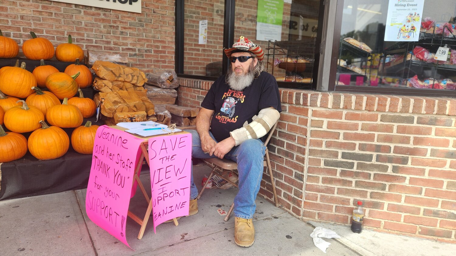 Tim Dunn sat outside the Stop & Shop on Forest Avenue for seven hours, surrounded by large neon-pink signs reading ‘Save the View.’