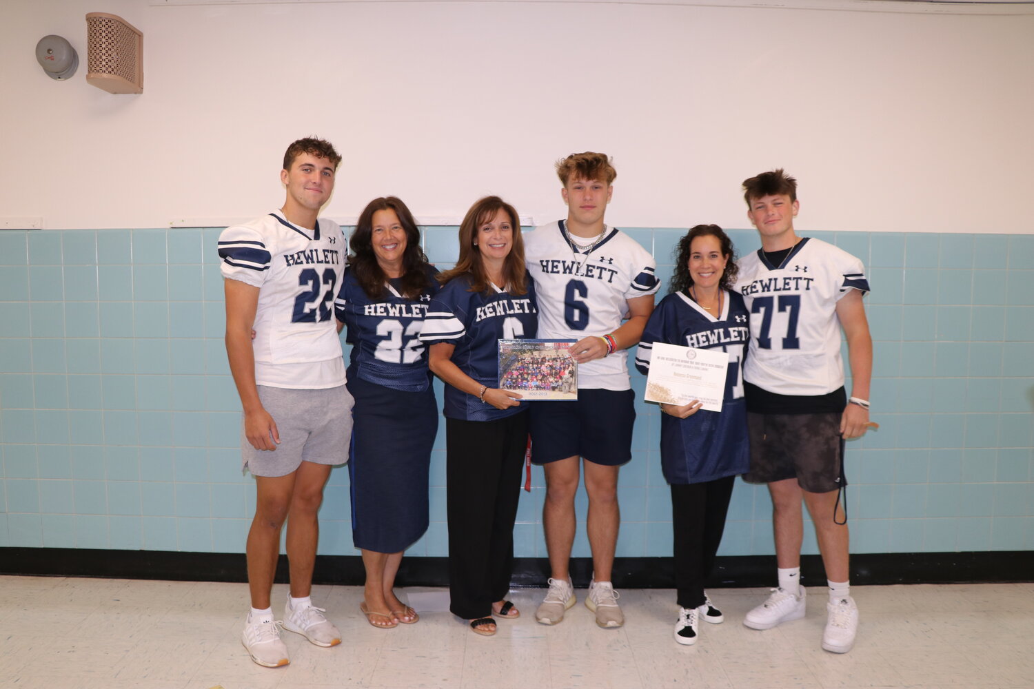 Hewlett High School football seniors visited the Franklin Early Childhood Center to invite their former teachers to be honored at a future football game. From left were Luke Rochler, Nancy Polakoff, FECC principal Lorraine Smyth, Spencer Smith, Rebecca Greenseid and Danny Sheinin.