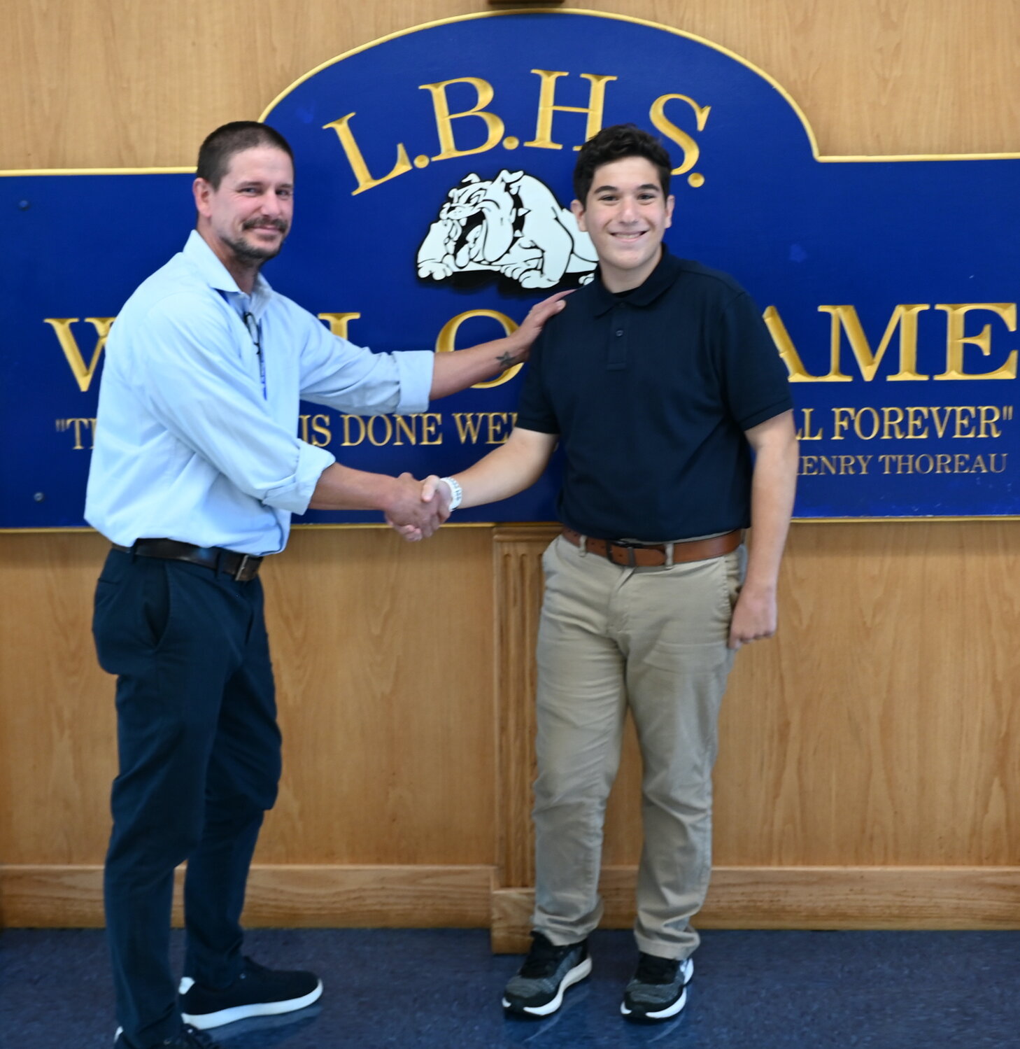 Long Beach High School National Merit Semifinalist Samuel Adler was congratulated by his guidance counselor, Erik Steinmetz.