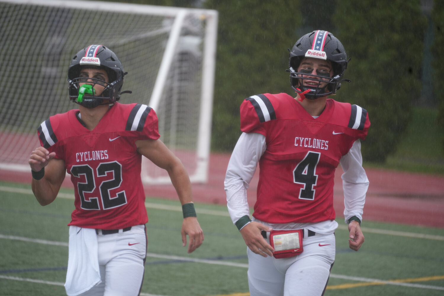 Wide receiver Michael Melkonian (22) and quarterback Owen West (4) celebrating a dominating win over Mineola, 56-0.