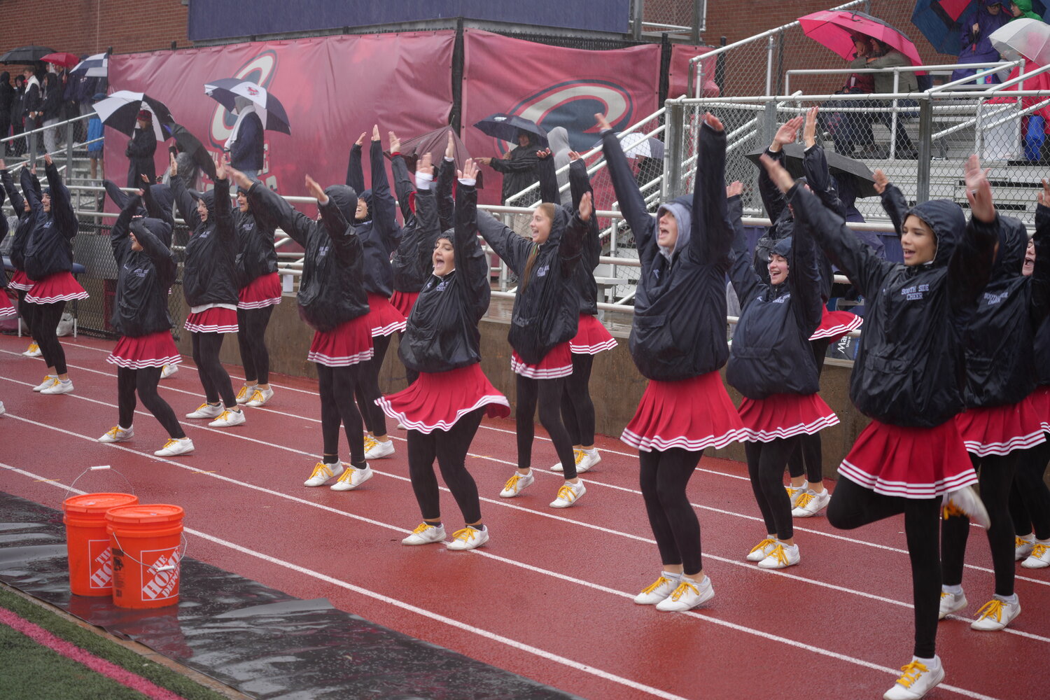 The South Side cheer team came to support the football squad despite the rainy weather.