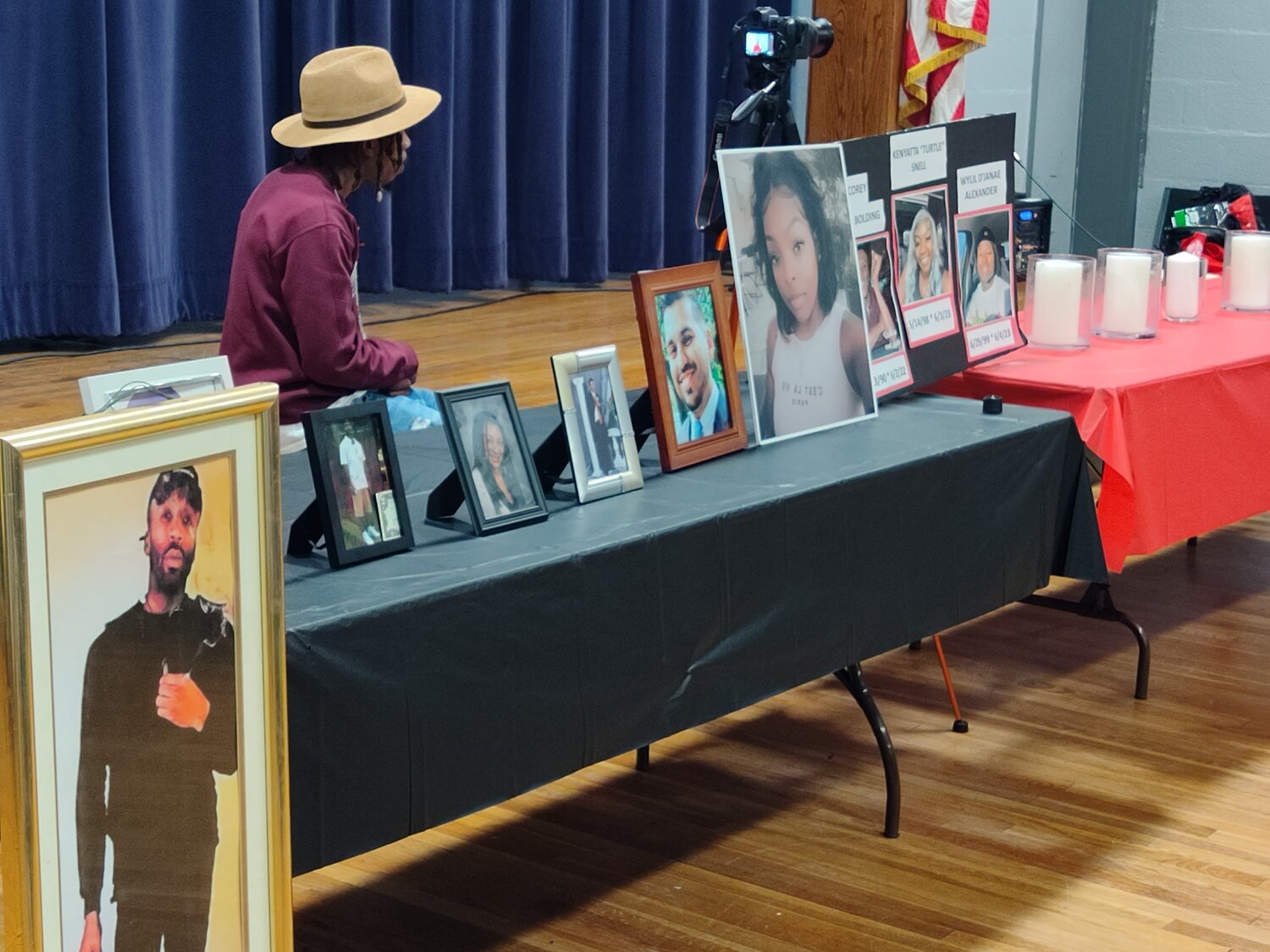 Photos placed by families of local people murdered by guns or other weapons occupied the front table at a remembrance ceremony at Kennedy Park on Sept. 22.
