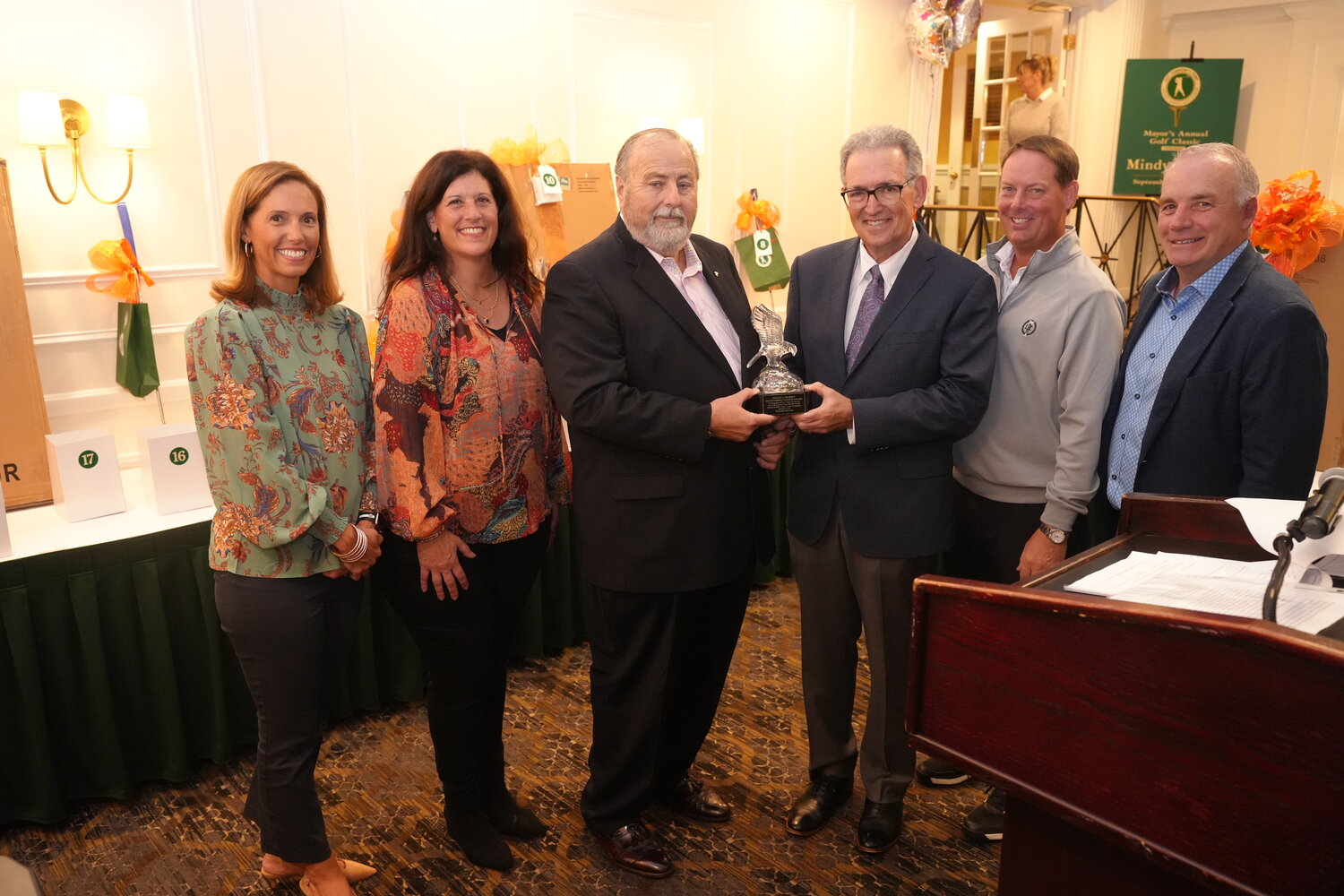 Rockville Centre Mayor Francis Murray, center, presents the Eugene J. Murray Outstanding Service Award to Wayne Lipton during the 36th annual Golf and Dinner Classic on Thursday evening. Joining them are Village Trustee Katie Conlon, left, Deputy Mayor Kathy Baxley, Village Trustee Greg Shaughnessy, second from right, and Village Trustee Emilio Grillo.