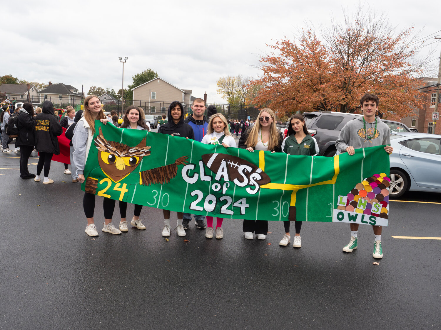 Seniors with a their football-themed banner.