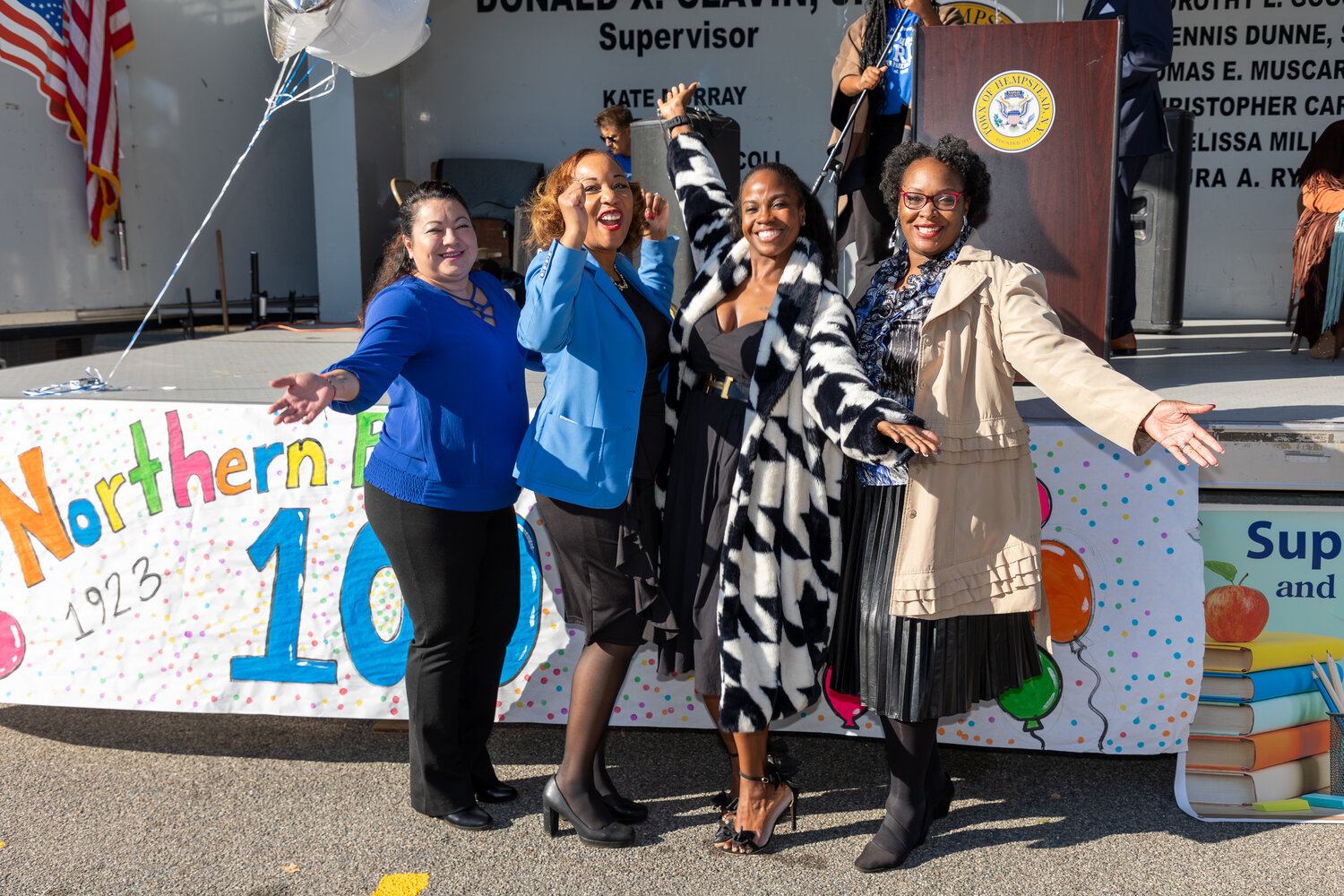 Uniondale Board of Education Trustee Addie Blanco-Harvey, district Superintendent Monique Darrisaw-Akil, Assemblywoman Taylor Darling and school board Trustee Charmise Desiré gave a victory flourish at the 100th anniversary celebration of Northern Parkway School.