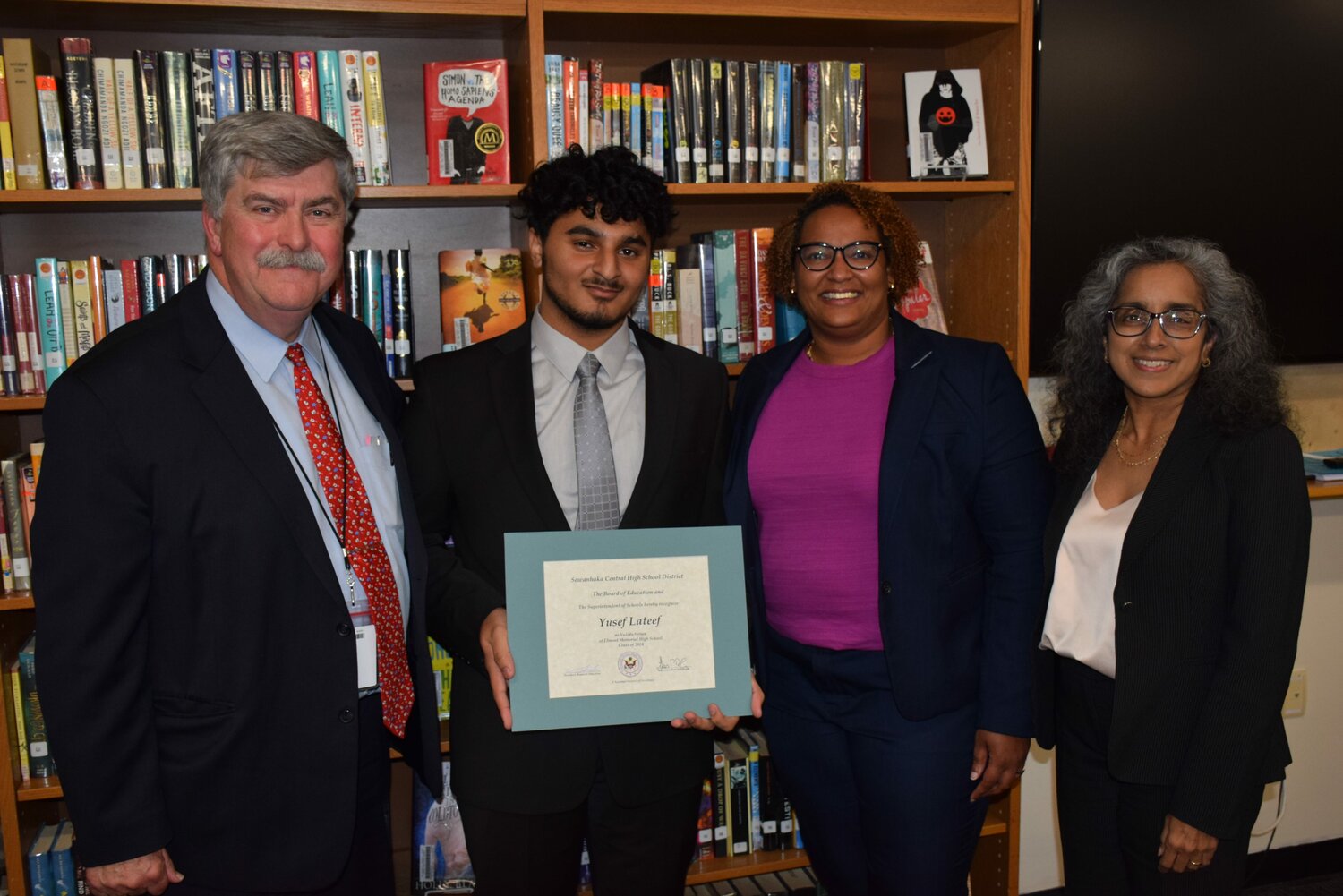 Dr. Thomas Dolan, Sewanhaka school district’s interim superintendent, congratulated Yusef Lateef, Elmont Memorial High School Class of 2024 valedictorian, for his educational feats. Board of Education trustee Tiffany Capers and principal Marya Baker joined them.