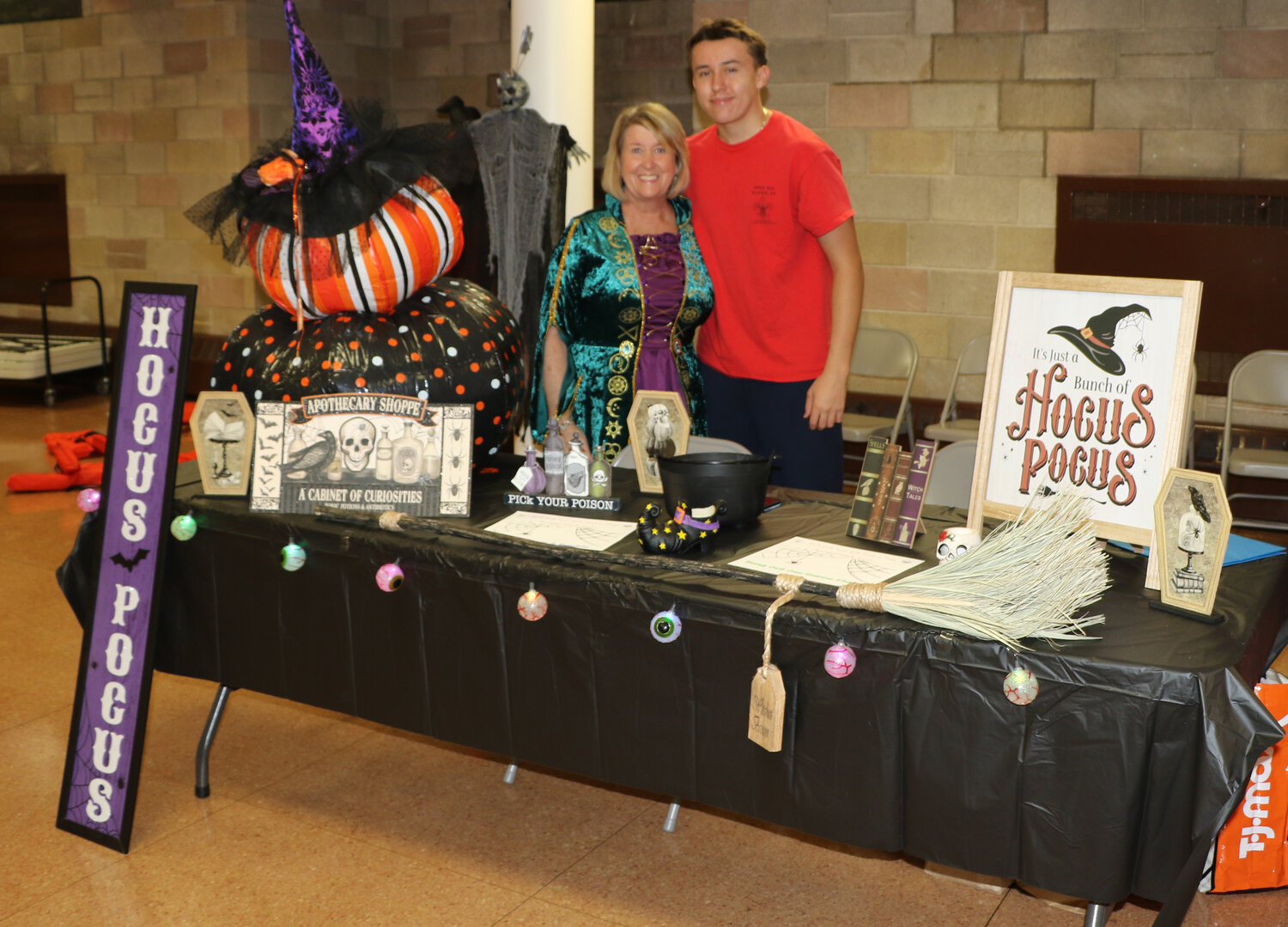Kimberly Casio with her son CJ Casio at their table that is decorated as Hocus Pocus. The table won first place for best Halloween table set.