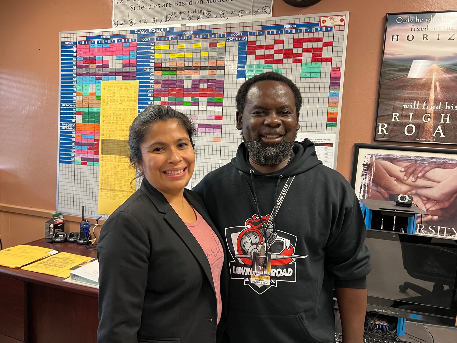 Lawrence Road Middle School teacher Veronica Argueta, a member of the school’s Equity Team, and Principal Dexter Hodge worked with the Lawrence Road and Uniondale district staff to revise the complicated scheduling board, seen on the wall behind them.