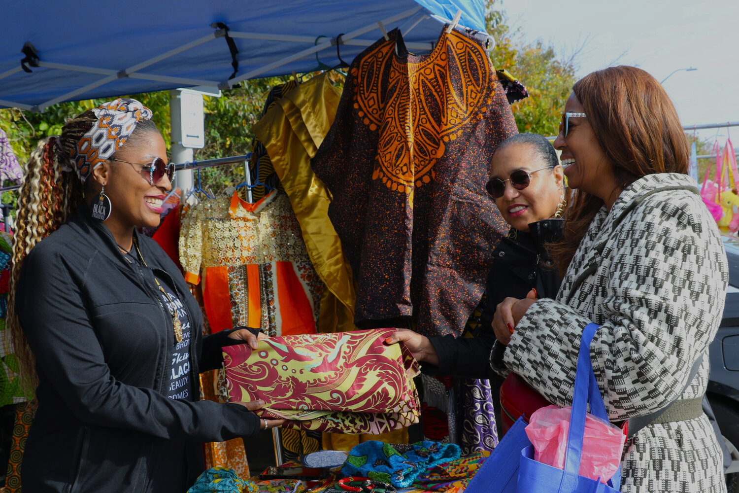Chioma Okoro had many vibrant clothes, which Michelle Kemp and Diana Soares found a few colorful items to purchase.