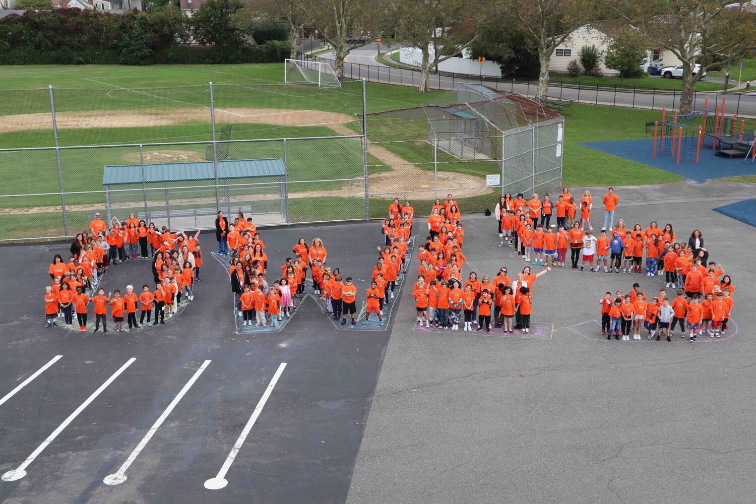 The students and staff of Waverly Park Elementary School gathered on the blacktop to spell out “OWLS” for Unity Day on Oct. 18.