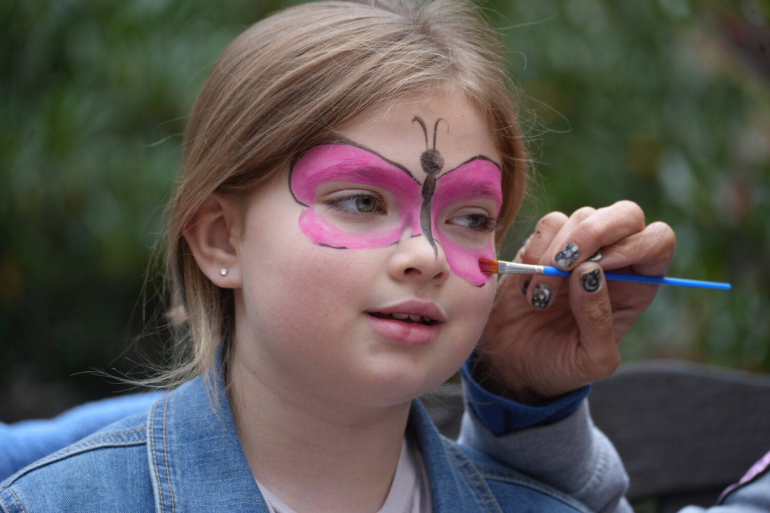 Charlotte Ruge, 8, gets her face painted at St. Jude’s Country Fair in Wantagh.