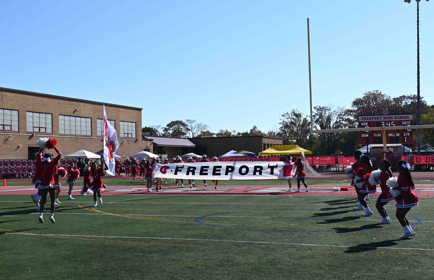 Freeport varsity football team taking the field during homecoming 2023 against the Baldwin Bruins.