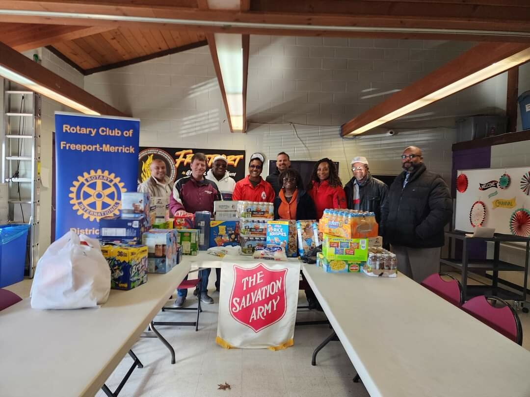 The Freeport-Merrick Rotary Club donates food to the Salvation Army.