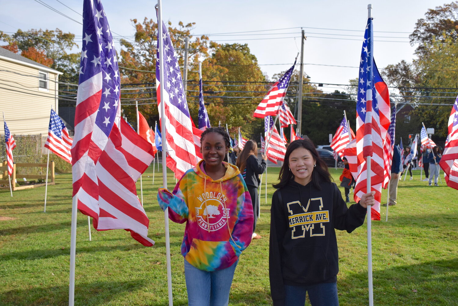 Dariella Mauricette and Jiana Tomasello worked together to install flags in the ground.