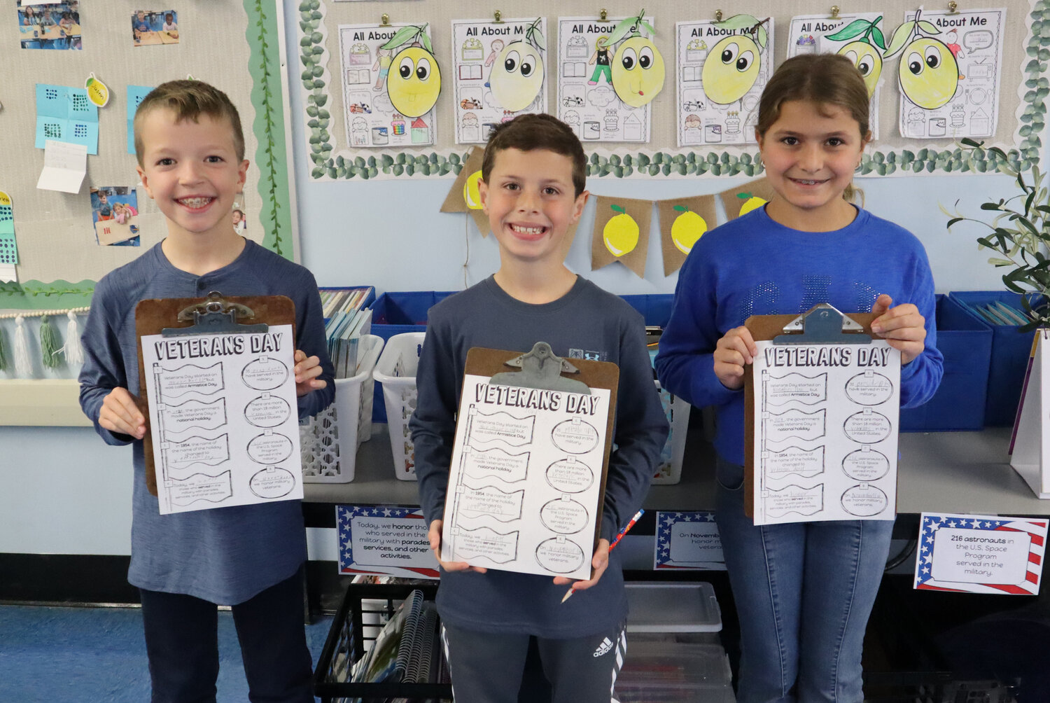 Lee Road third graders Dylan Kemnah, left, John Maddalena and Scarlett Cippoletti searched for various facts about Veterans Day.