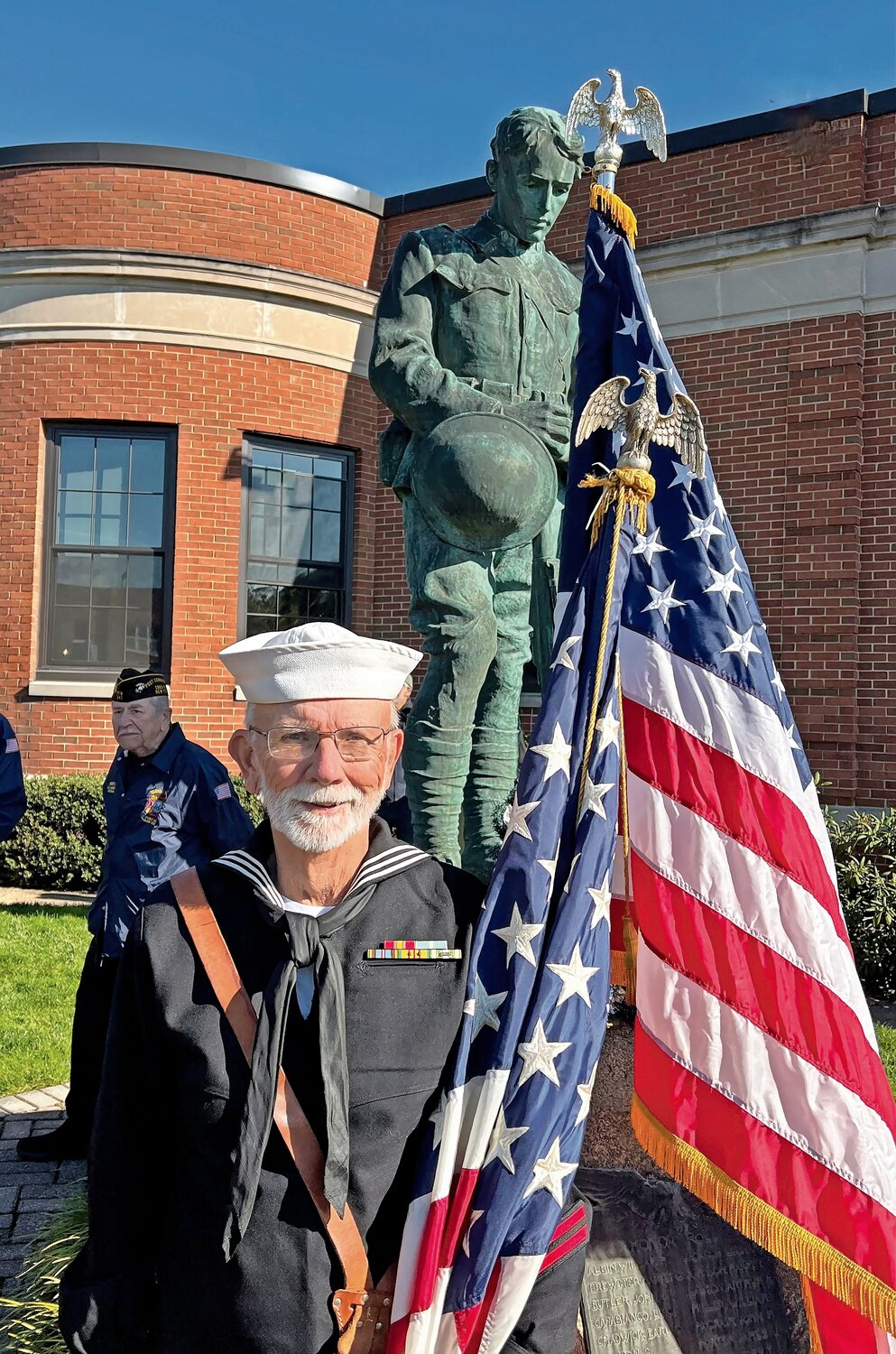 Dave Christie proudly held the American Flag to honor veterans.
