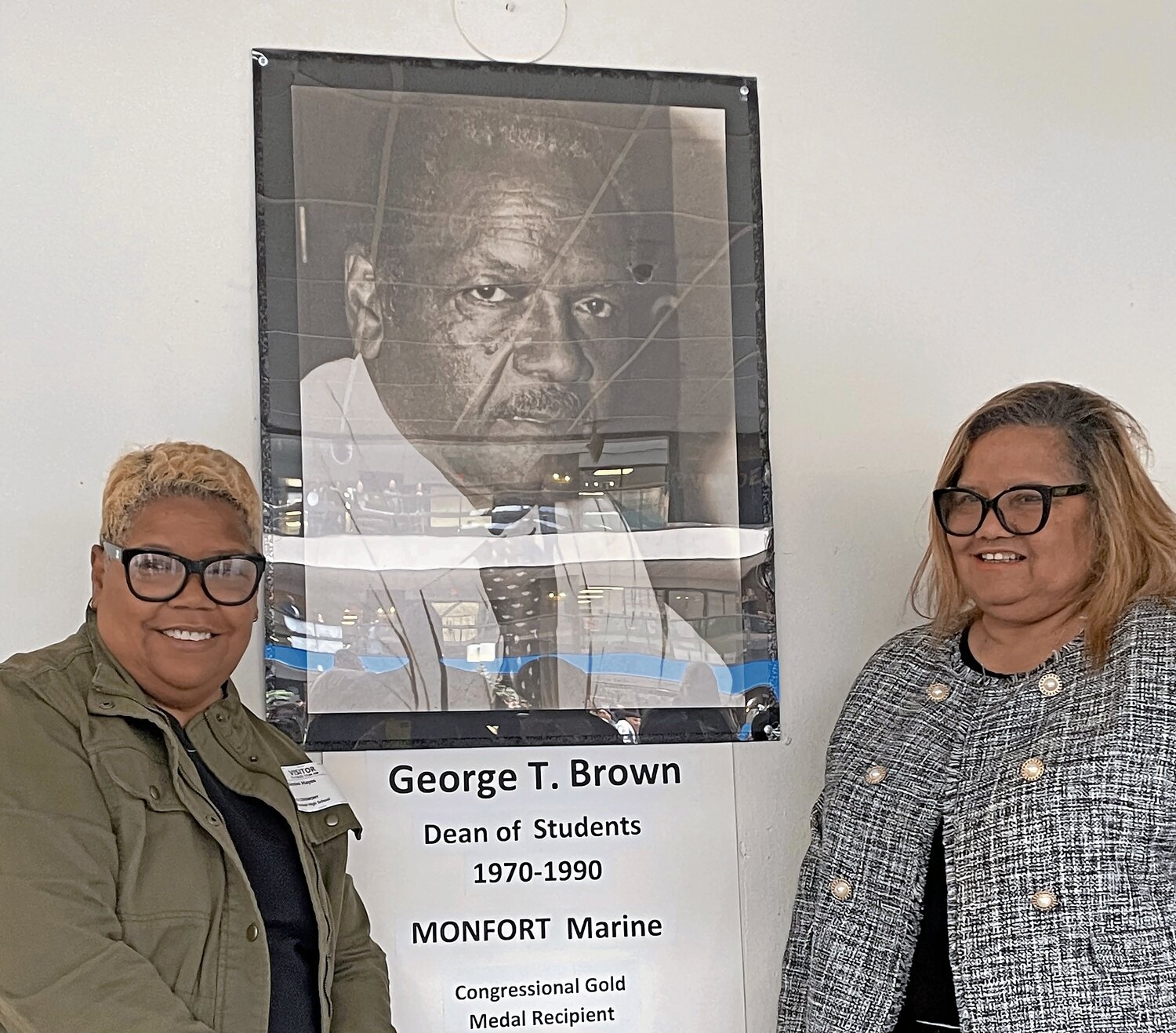 Bimini Brown Hayes, left, and her sister Olga Brown-Young proudly stood by the plaque commemorating their father, Montford Point Marine veteran George T. Brown, when the atrium of Hempstead High’s Classroom Building A was dedicated to him on Tuesday.
