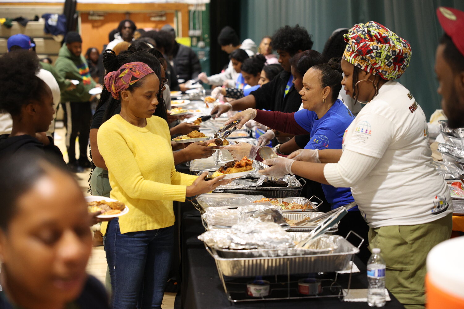Neighbors dug in as they filled their plates with the help of volunteers at the event last weekend.