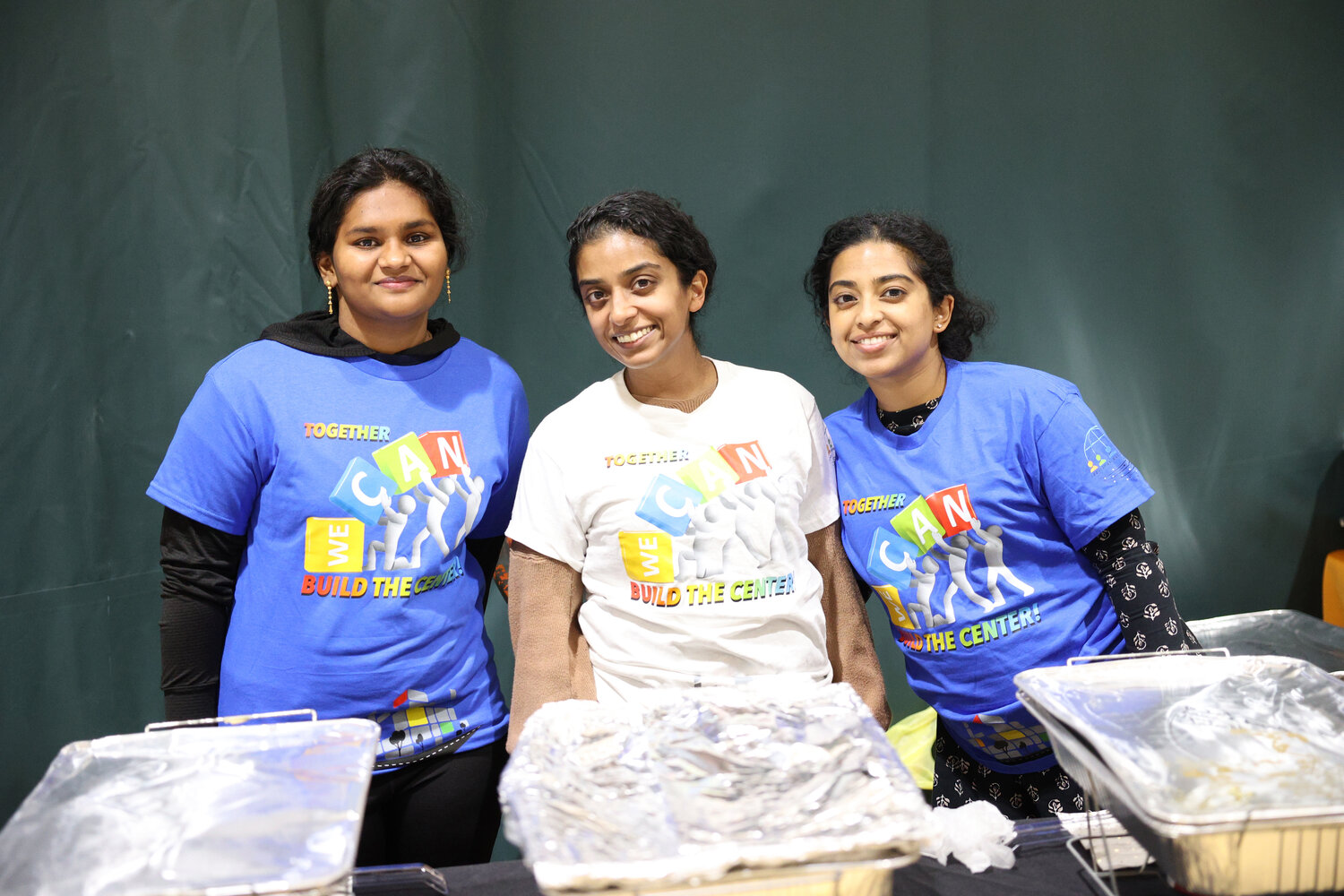 Aleena Joe, Zinnia Dodson and Dahlia Thomas all volunteered and lent a hand during the community dinner in Elmont.