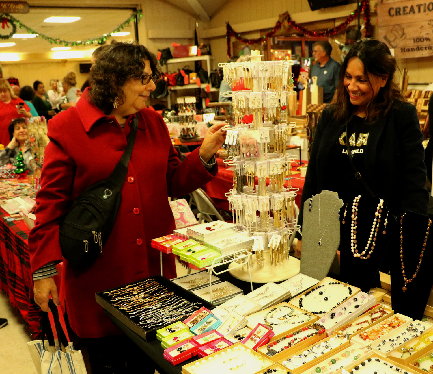 Anna DeSouza searched for some jewelry from Kay Yhap's Bijoux Jewelers during the second annual holiday craft and gift boutique hosted by Rescuing Families on Nov. 18 and 19.