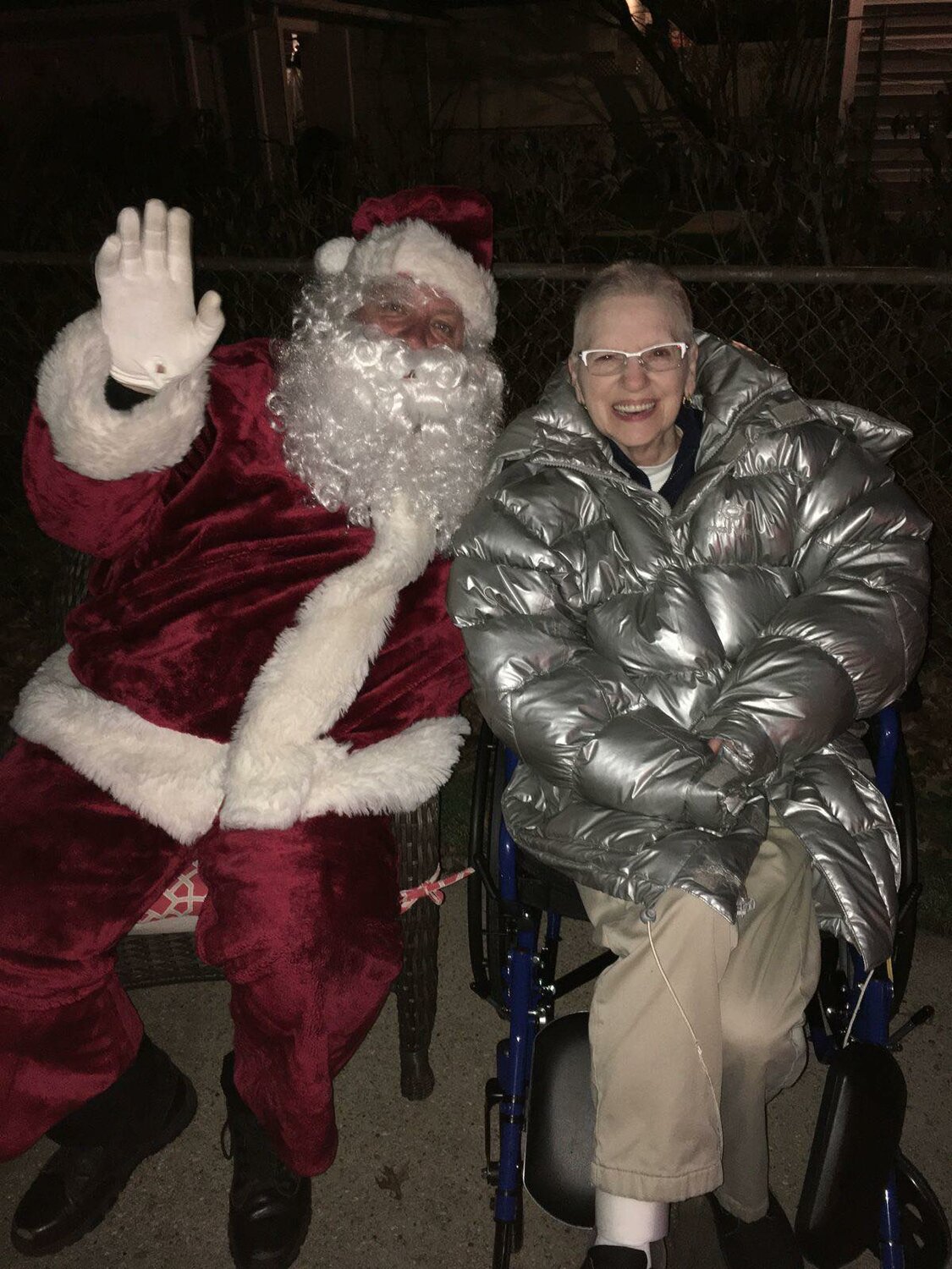 Santa with Joan Giles, whose wish came true when her 85-foot-tall tree was decorated with lights for Christmas.