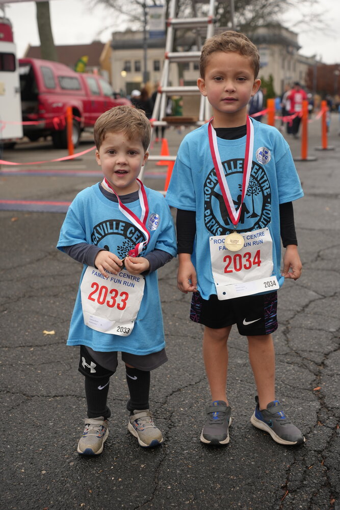 William Caulfield, 3, and Gerald Caulfield, 6, of Rockville Centre, celebrate after participating in the family fun run on Saturday.