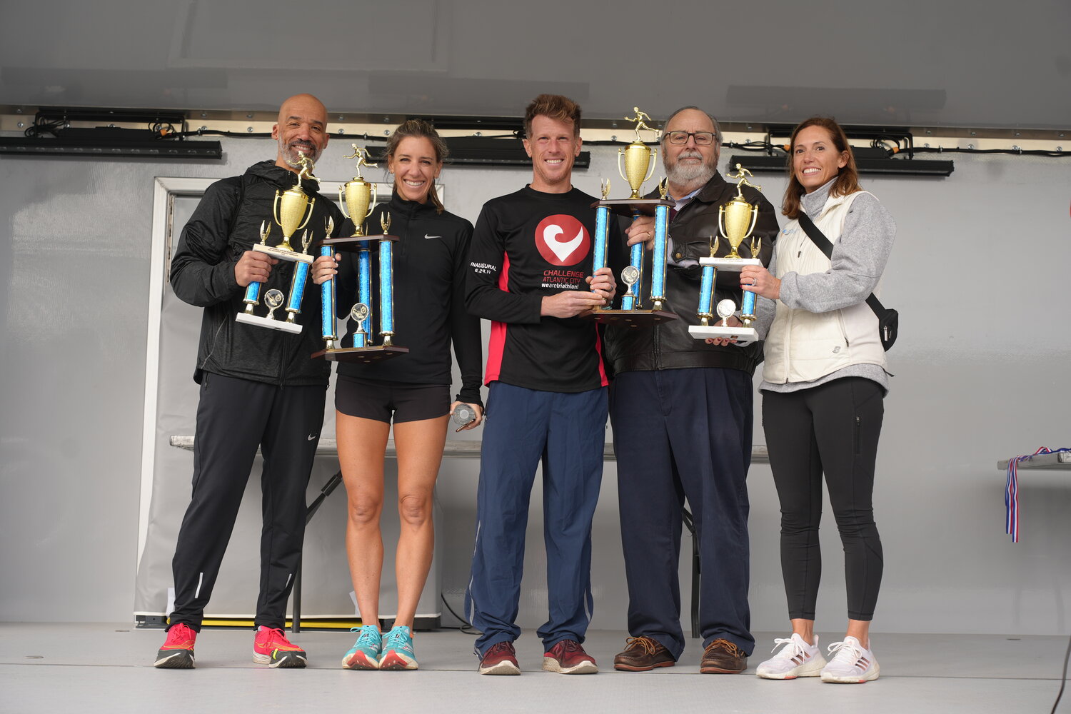 Samantha Augeri, second from left, and David Putterman, center, were presented with first-place trophies for their performance during the annual 5k race. Nassau County Legislator-elect Scott Davis, Rockville Centre Mayor Francis Murray and Village Trustee Katie Conlon join them in presenting the awards.