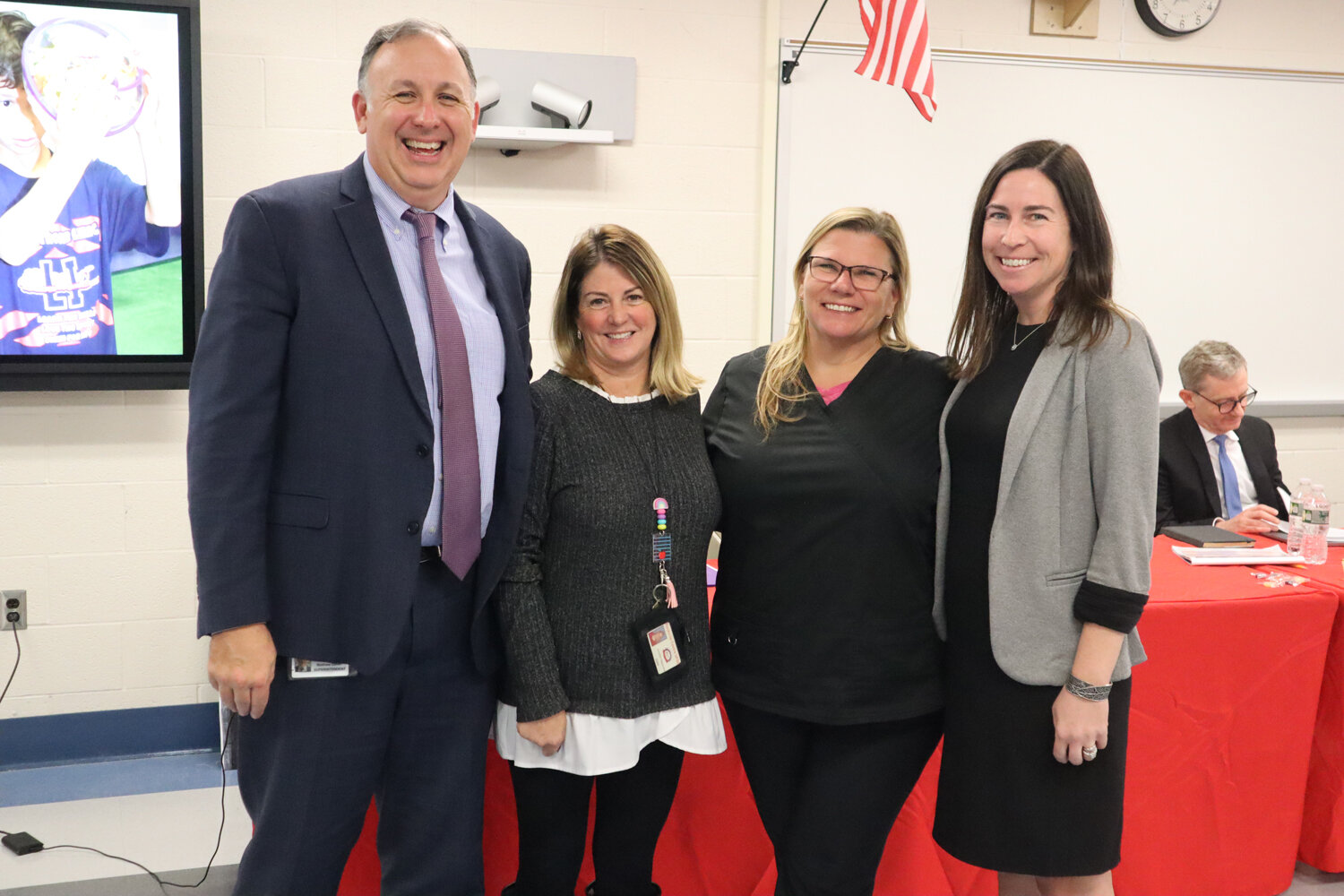 Rockville Centre School District Superintendent Matt Gaven, left, and Kelly Barry, president of the RVC Board of Education, right, express their thanks to Watson Principal Jen Pascarella and school nurse Laura Lanning for taking swift action to help save a person’s life.