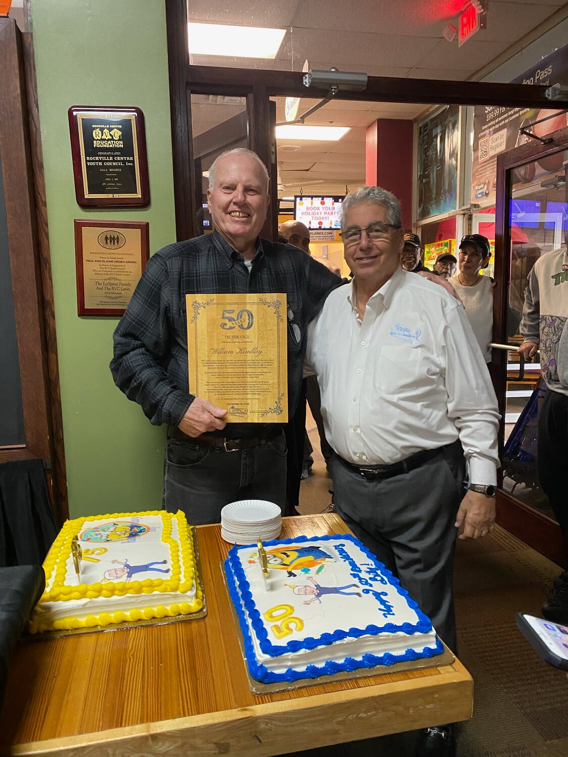 William Kimbley, left, head mechanic at Maple Lanes RVC, receives recognition for his 50 years of service from Joe LaSpina, vice president of Maple Family Centers.
