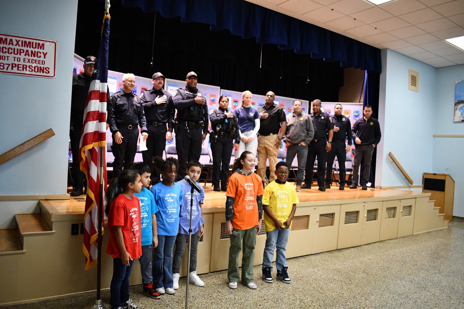 Students in the Leo F. Giblyn Elementary School color guard led the Pledge of Allegiance to kick off the school’s annual Adopt-a-Cop ceremony.