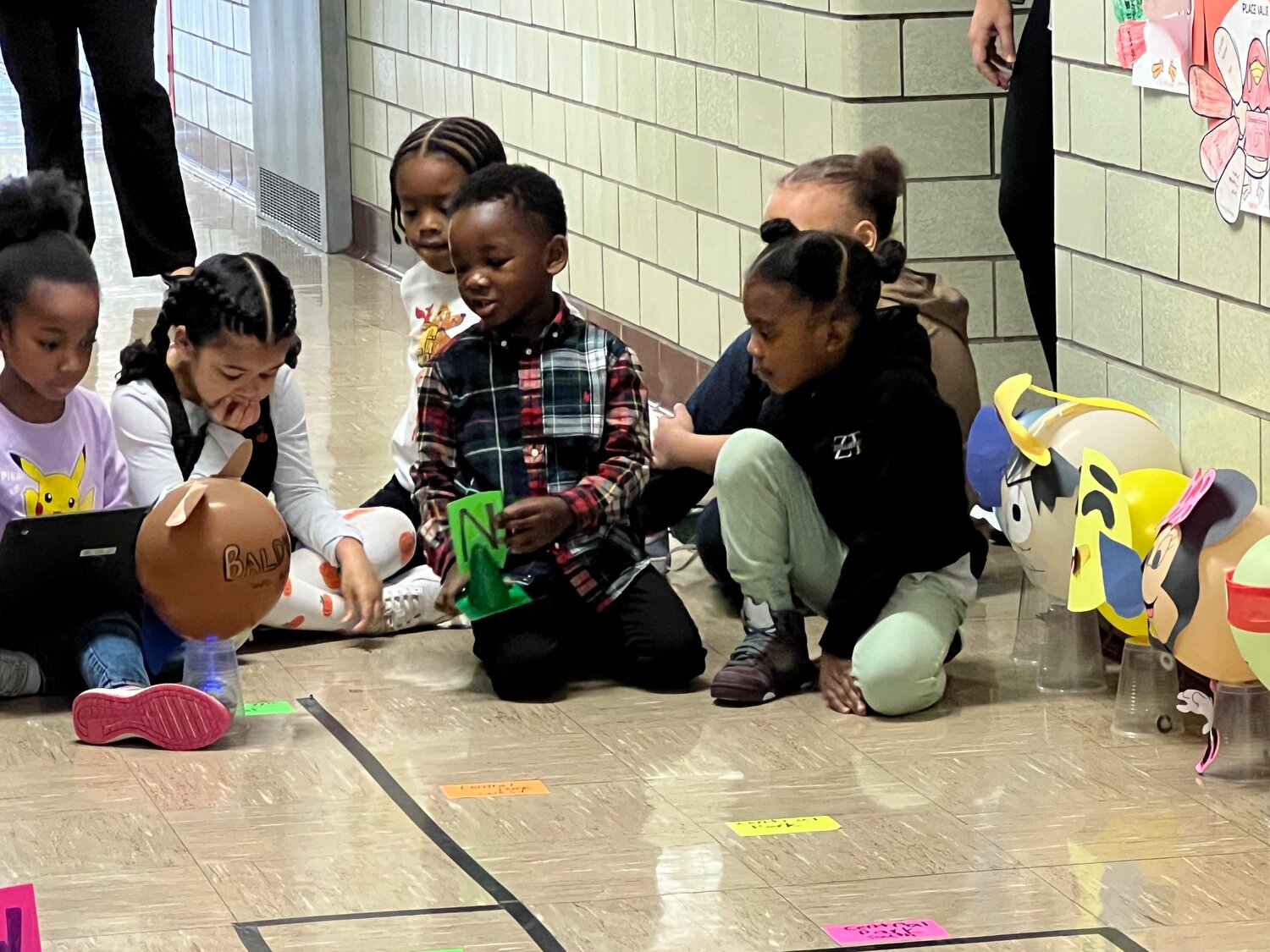 Brookside Elementary School students working to recreate the Macy’s Thanksgiving Day Parade. They used Spheros to move balloons they designed along a small version of the Manhattan parade route.