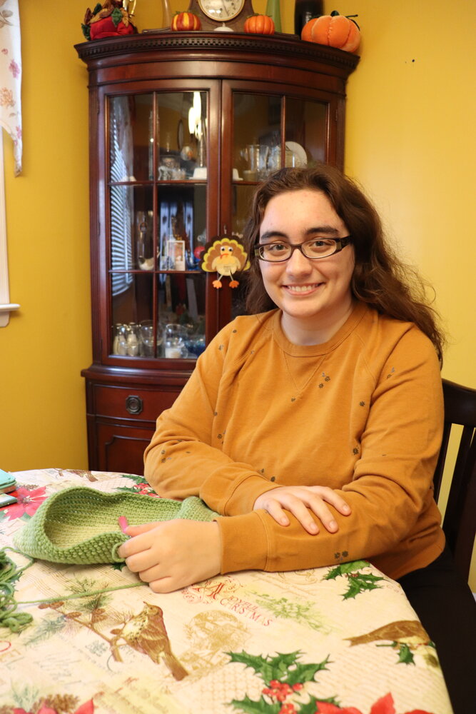 Franklin Square resident Jessica Pormigiano, a 19-year-old with selective mutism, selling hand-crocheted potholders at Rescuing Families community marketplaces and craft boutiques throughout the year.