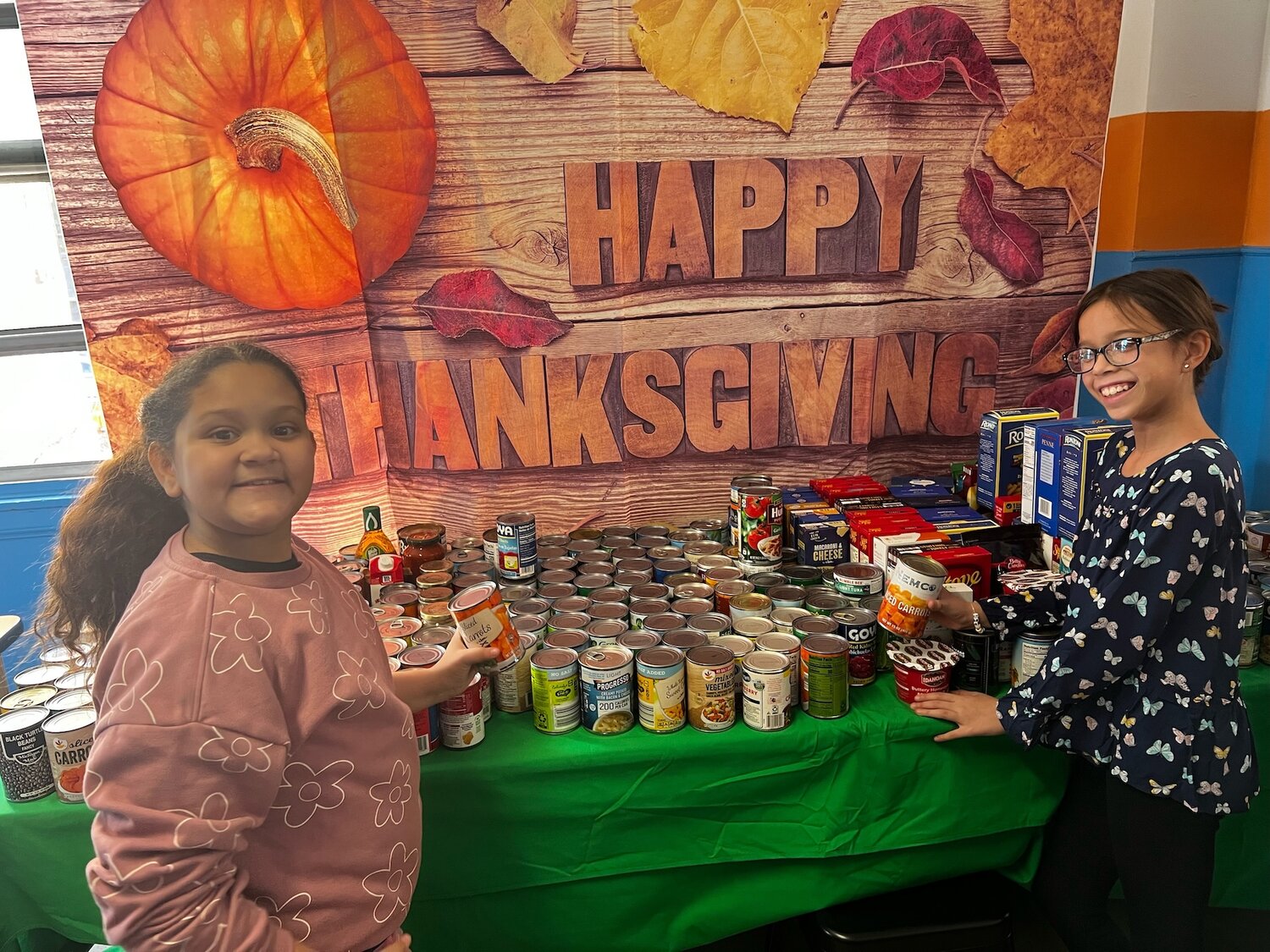 Davison Avenue students show off their food donations collected for the I.N.N. in Hempstead, which helps people struggling with food insecurity or homelessness.