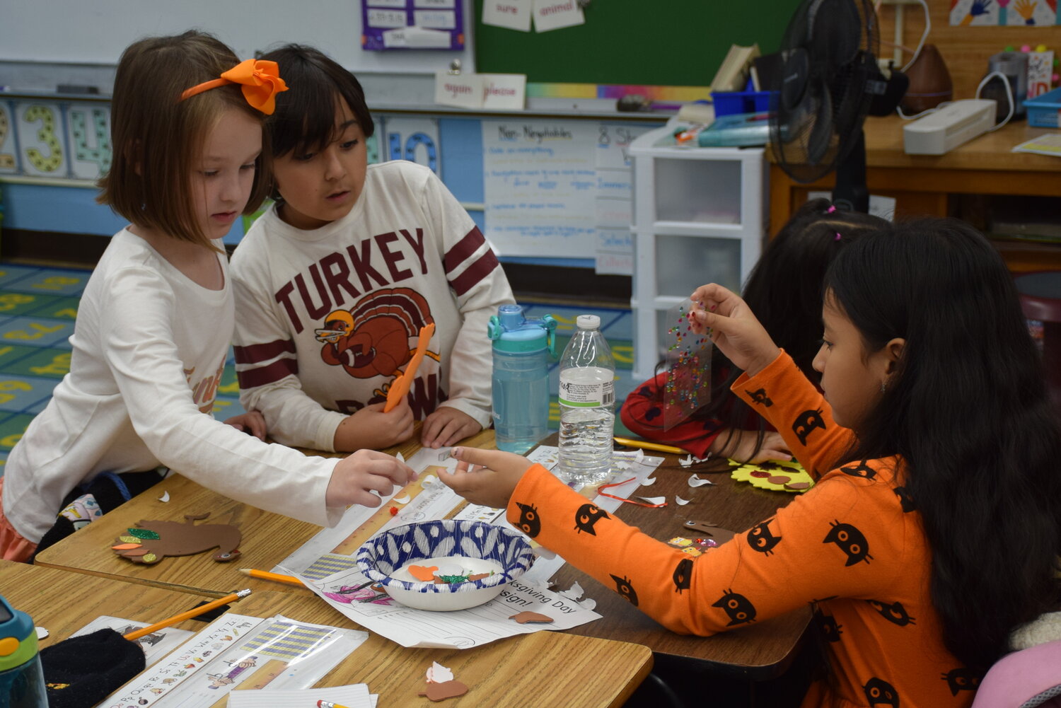 Students wore adorable festive outfits as they worked together to make Thanksgiving crafts.