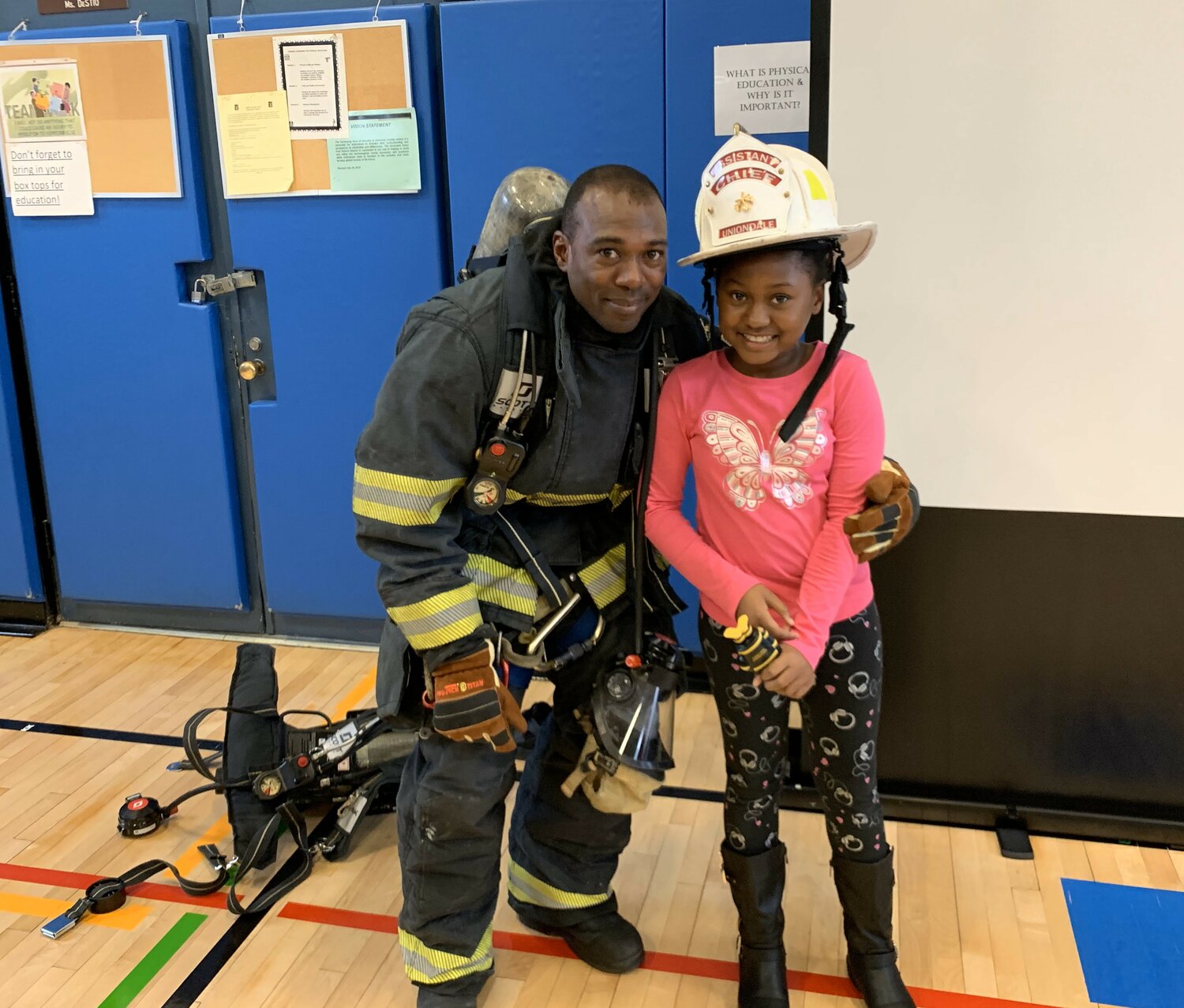 Ex-Chief and current Lieutenant Avril Ashley gave his daughter May, then 6 years old, a taste of wearing a firefighter’s uniform. Lt. Ashley has been with the Uniondale Fire Department for 17 years.