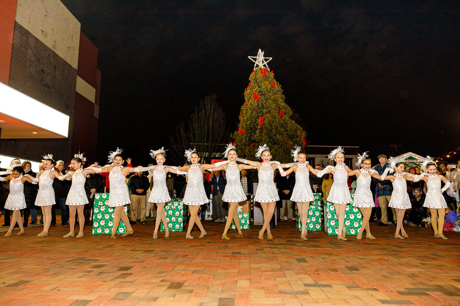 Young dancers from the Long Island Dance Workshop, clad in festive costumes, performed a joyful routine in front of the Christmas tree for onlookers during Lynbrook village’s annual tree lighting celebration.