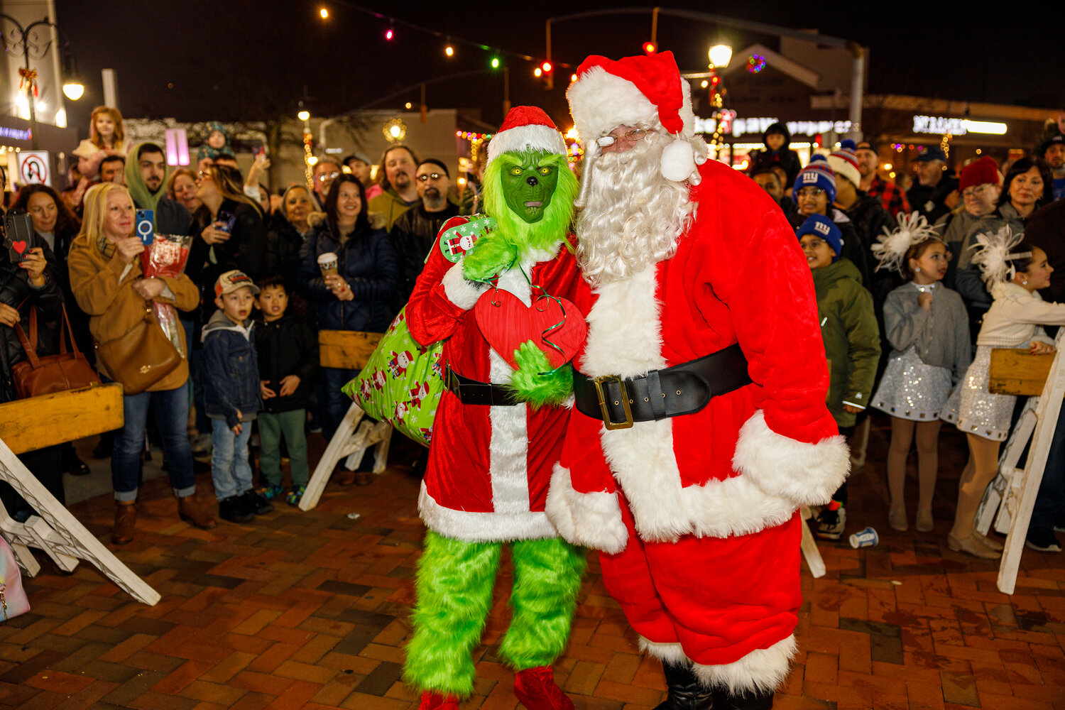 The Grinch and Santa Claus teamed up to spread holiday cheer around Lynbrook during the annual holiday celebration on Saturday.