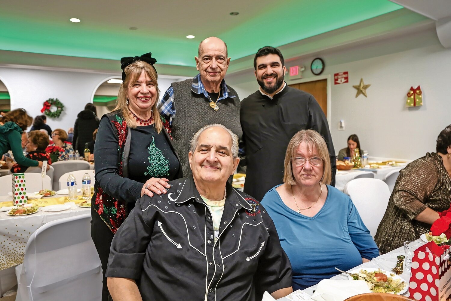 It was a very merry evening at the Greek Orthodox Panaghia Church. Father George Kazoulis,right, enjoyed the festivities with Joe Ponte, Ellen Ponte, Lisa Volts and Mike Ponte.
