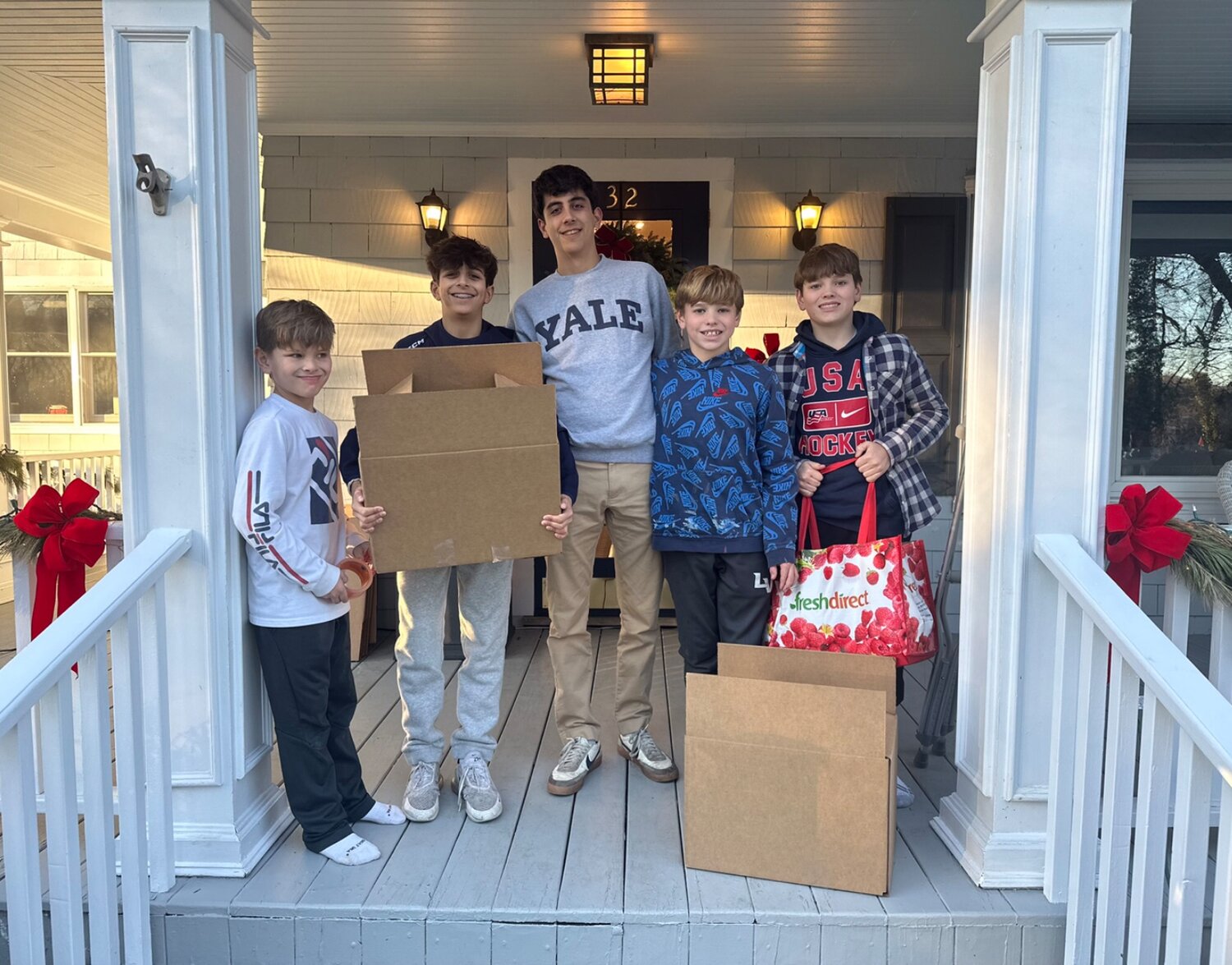 Lindsay Fox and Nitika Moran’s children are active in Friends of St. John’s. The week before Christmas, Brooks Fox, far left, Logan and Aidan Moran, and Tyler and James Fox delivered holiday meal boxes to a family.