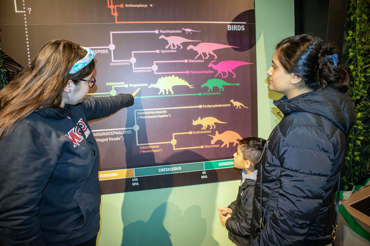 Emily Kulkarni explains to Aarti Kumar and Aavir Singh (Age 6) the ages of the dinosaurs.