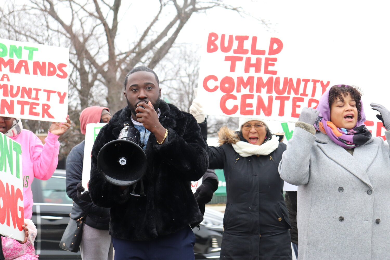 Fenol C. LaRock, an executive director of Elmont-based nonprofit Universal Interactions, Assemblywoman Michaelle Solages, and community members call for New York Arena Partners to fulfill its promise to build a community center in Elmont during a rally outside UBS Arena on Hempstead Turnpike last Sunday.