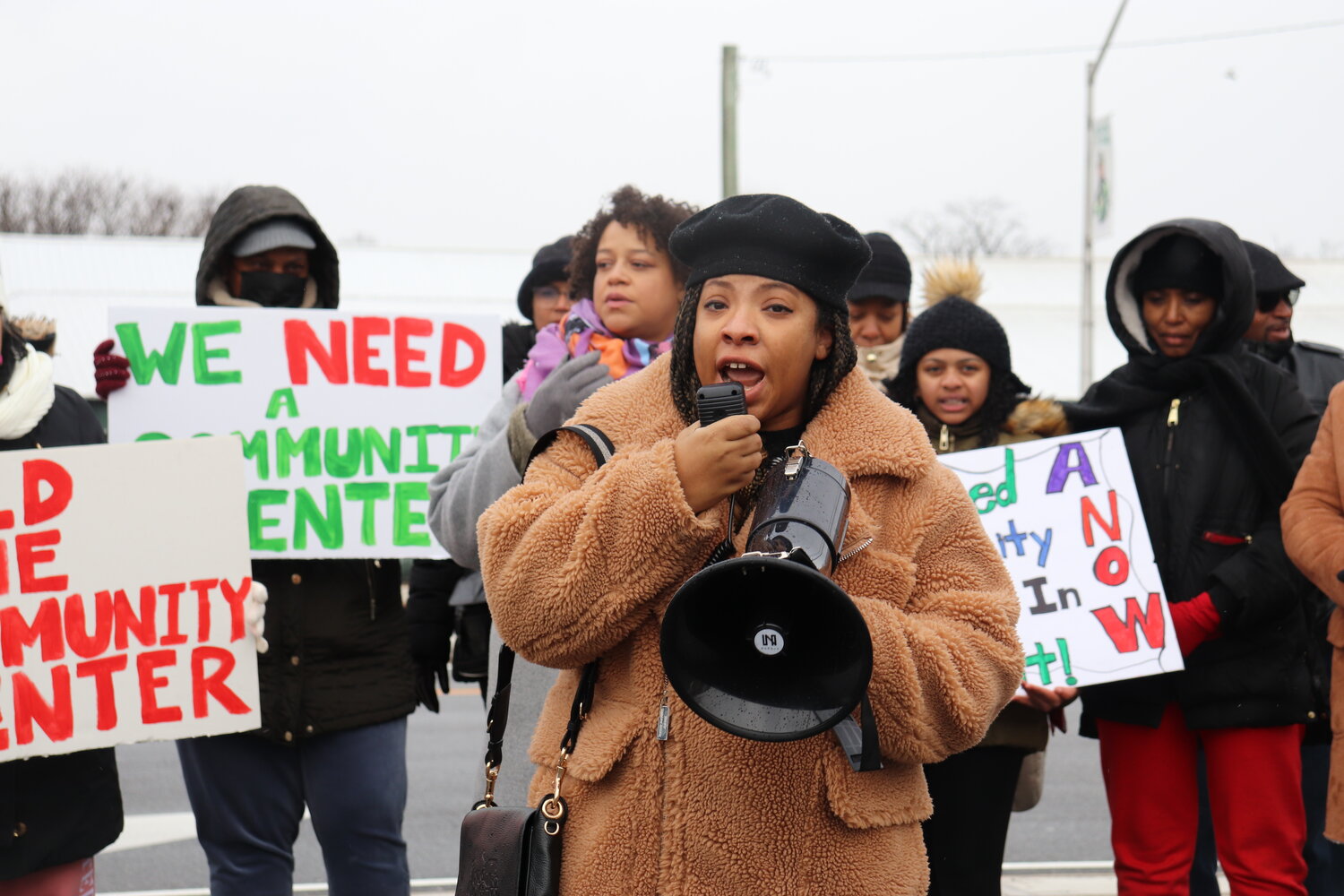 Tamar Paoli-Bailey, event coordinator and board member of the Elmont Cultural Center, and more than 20 community members gather on Hempstead Turnpike to rally for a community center in Elmont. A $1.3 billion Belmont Park Redevelopment Plan, announced in 2017, promised a 10,000-square-foot community center be built in Elmont. Five years later, the community is still waiting.